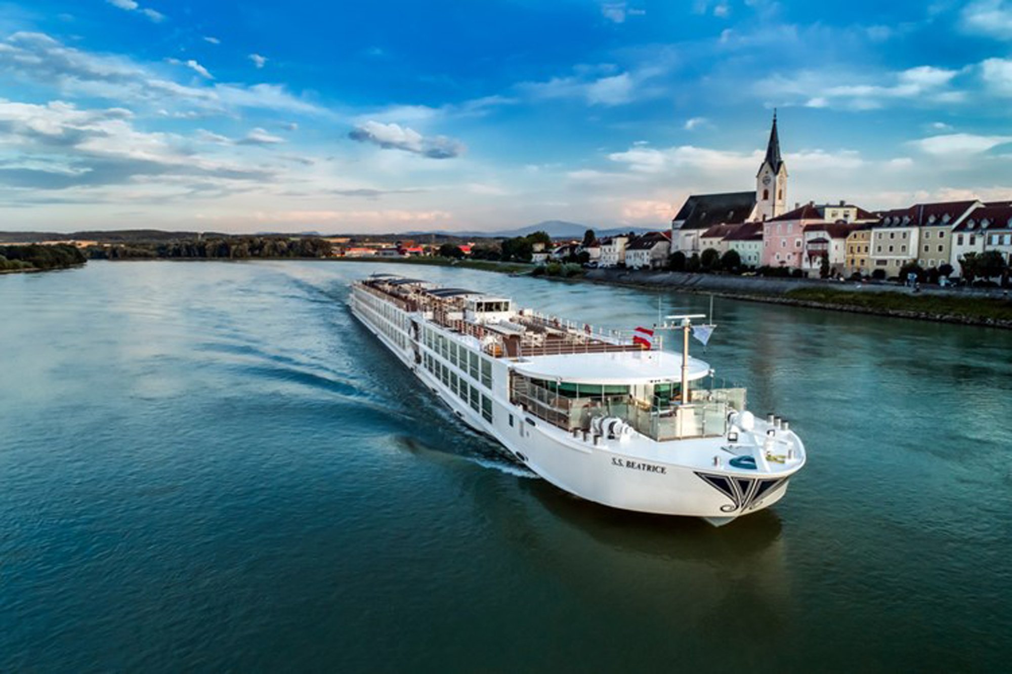 S.S. Beatrice river cruise ship navigating the Danube past a charming European riverside town