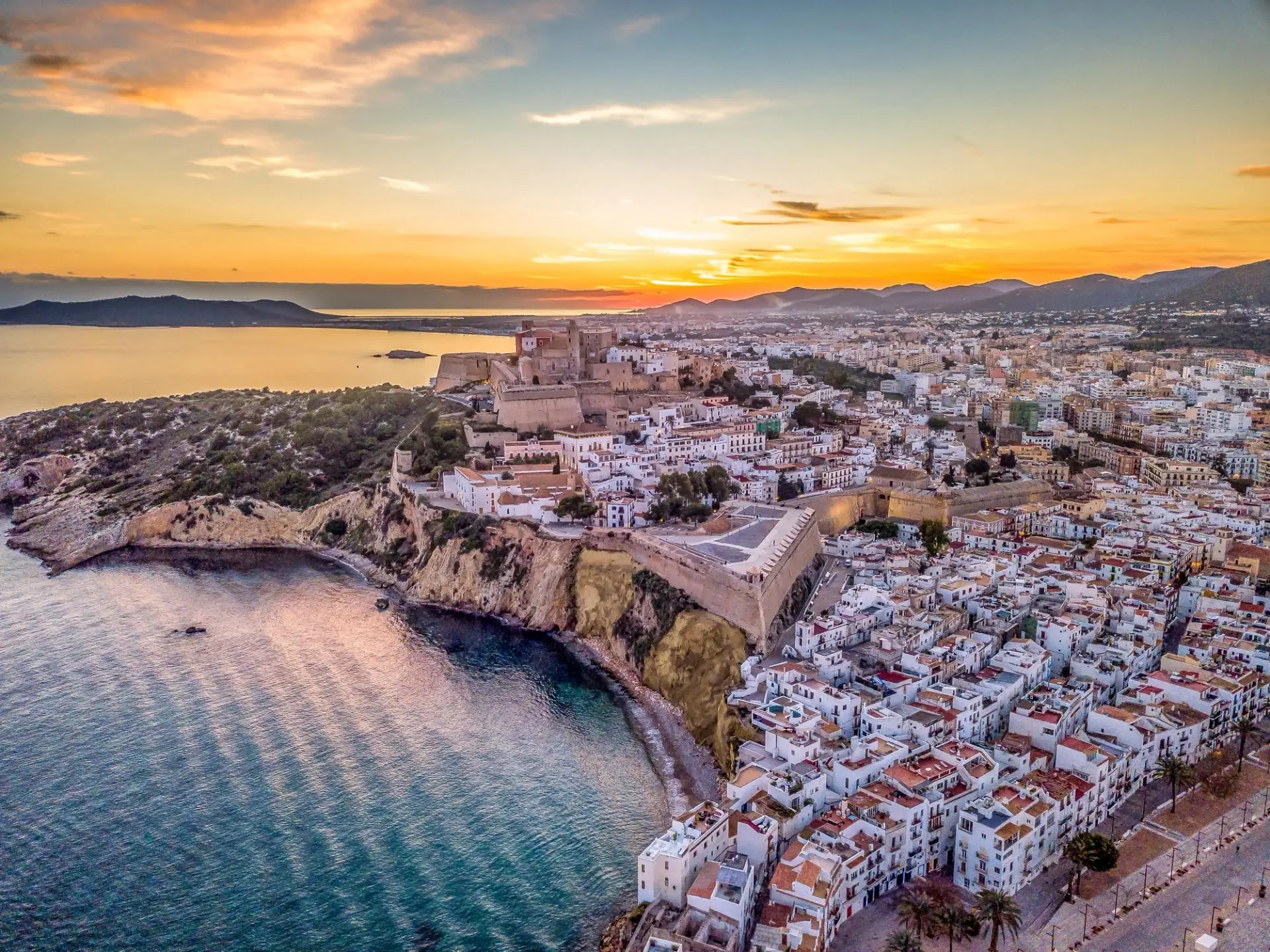 Denia Castle overlooking Mediterranean coast at sunset