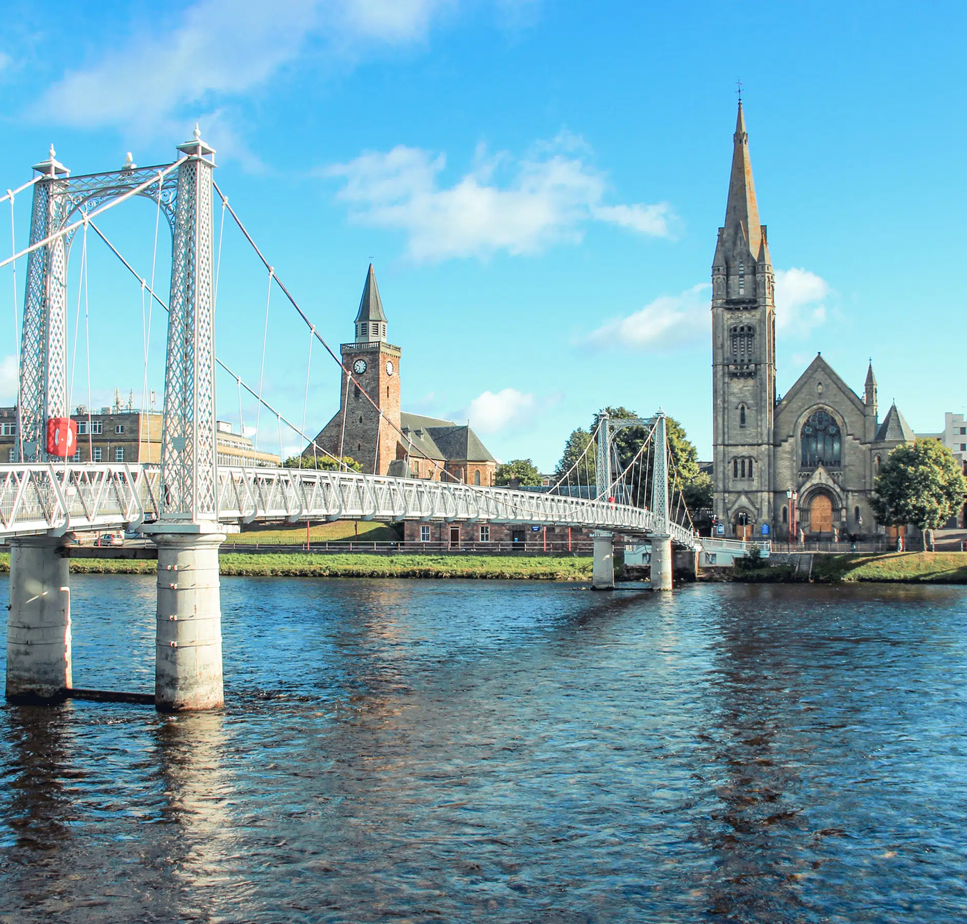 Albert Bridge and Churches in Inverness A picturesque view of the white ornamental Albert Bridge spanning the River Ness in Inverness
