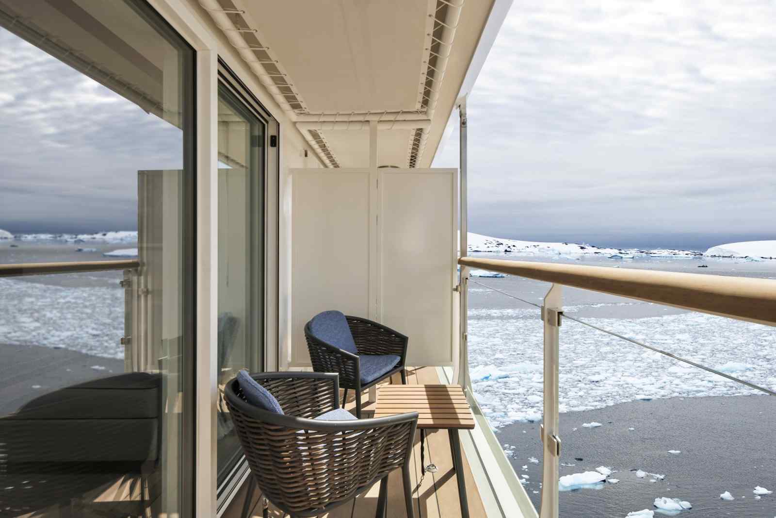 Arctic Cruise Balcony with Icy Seascape A private balcony on a cruise ship featuring woven chairs overlooking a frozen, ice-filled polar