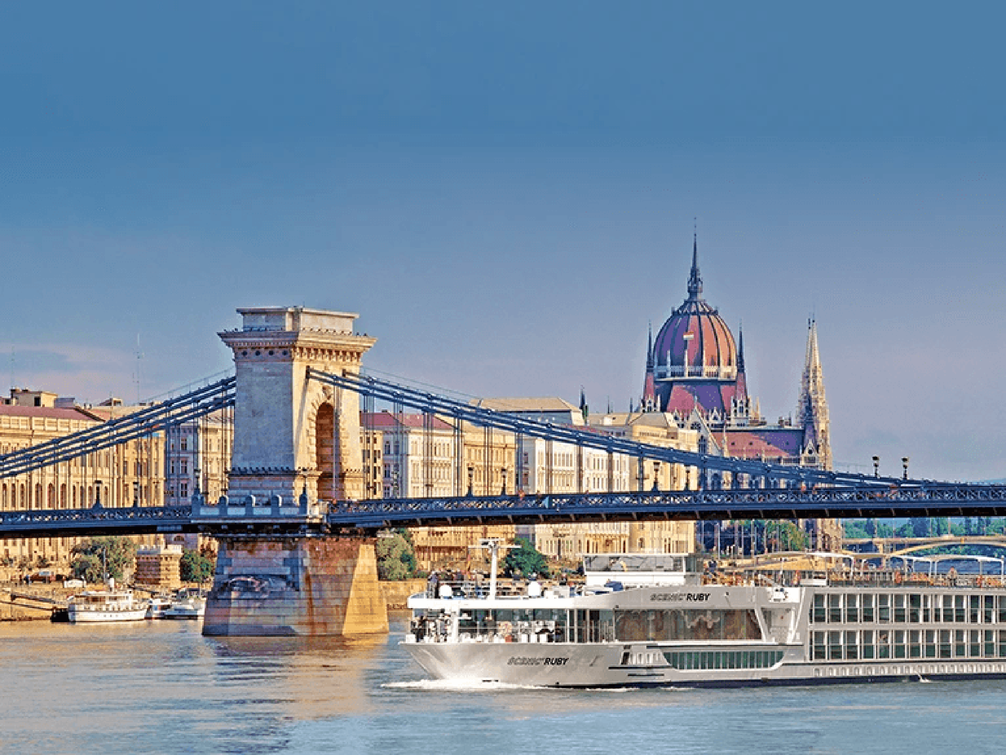 Budapest Chain Bridge and Parliament A scenic view of the iconic Chain Bridge spanning the Danube River with the Hungarian Parliament