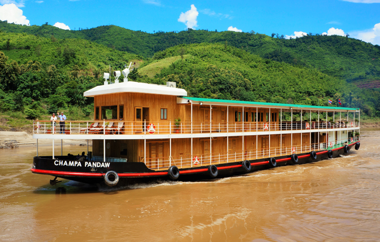 RV Champa Pandaw river cruise ship sailing through lush Southeast Asian landscape