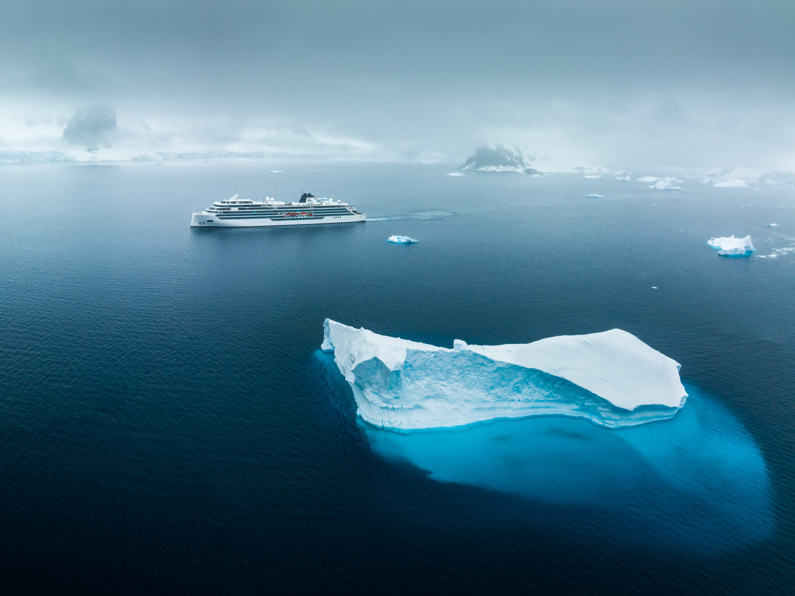Cruise Ship Navigating Icy Antarctic Waters Viking Octantis expedition ship navigating pristine Antarctic waters among massive icebergs