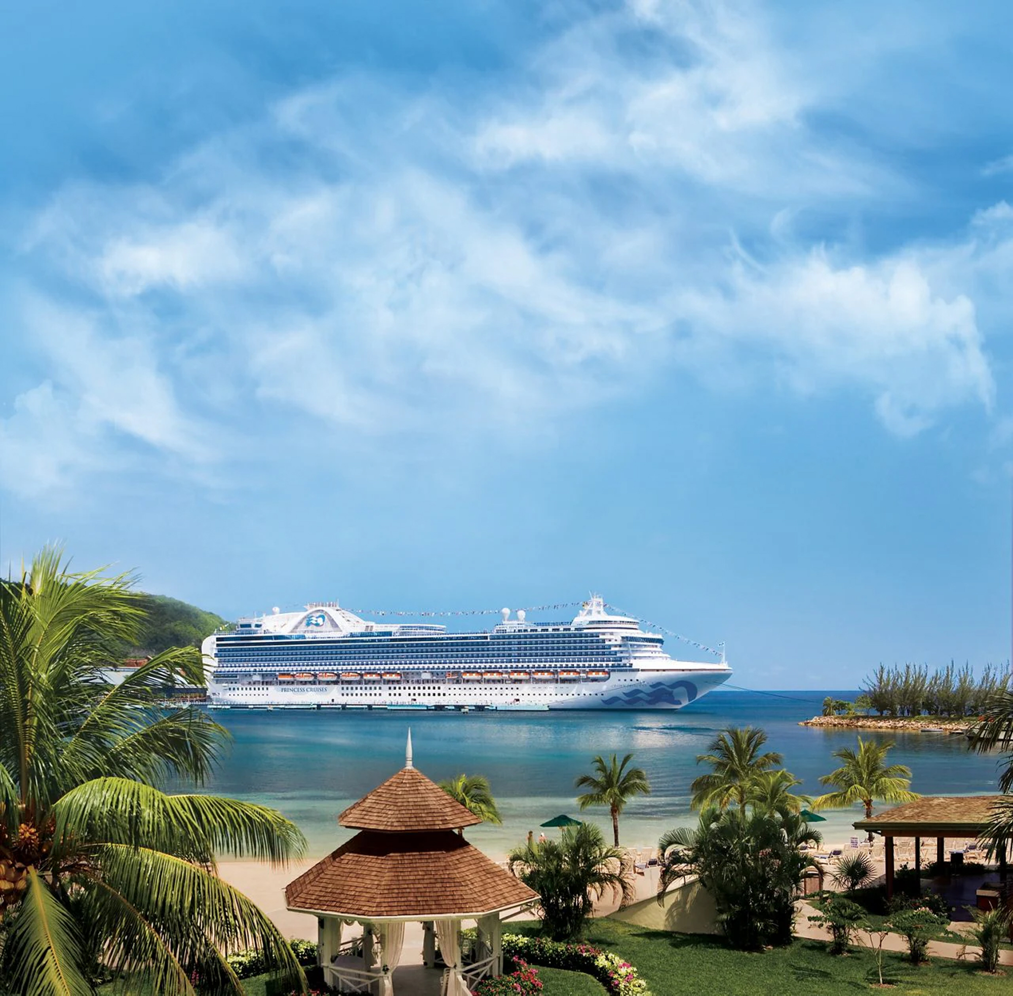 Cruise Ship at Tropical Caribbean Port A large white Princess Cruises ship anchored in a beautiful turquoise bay with palm trees