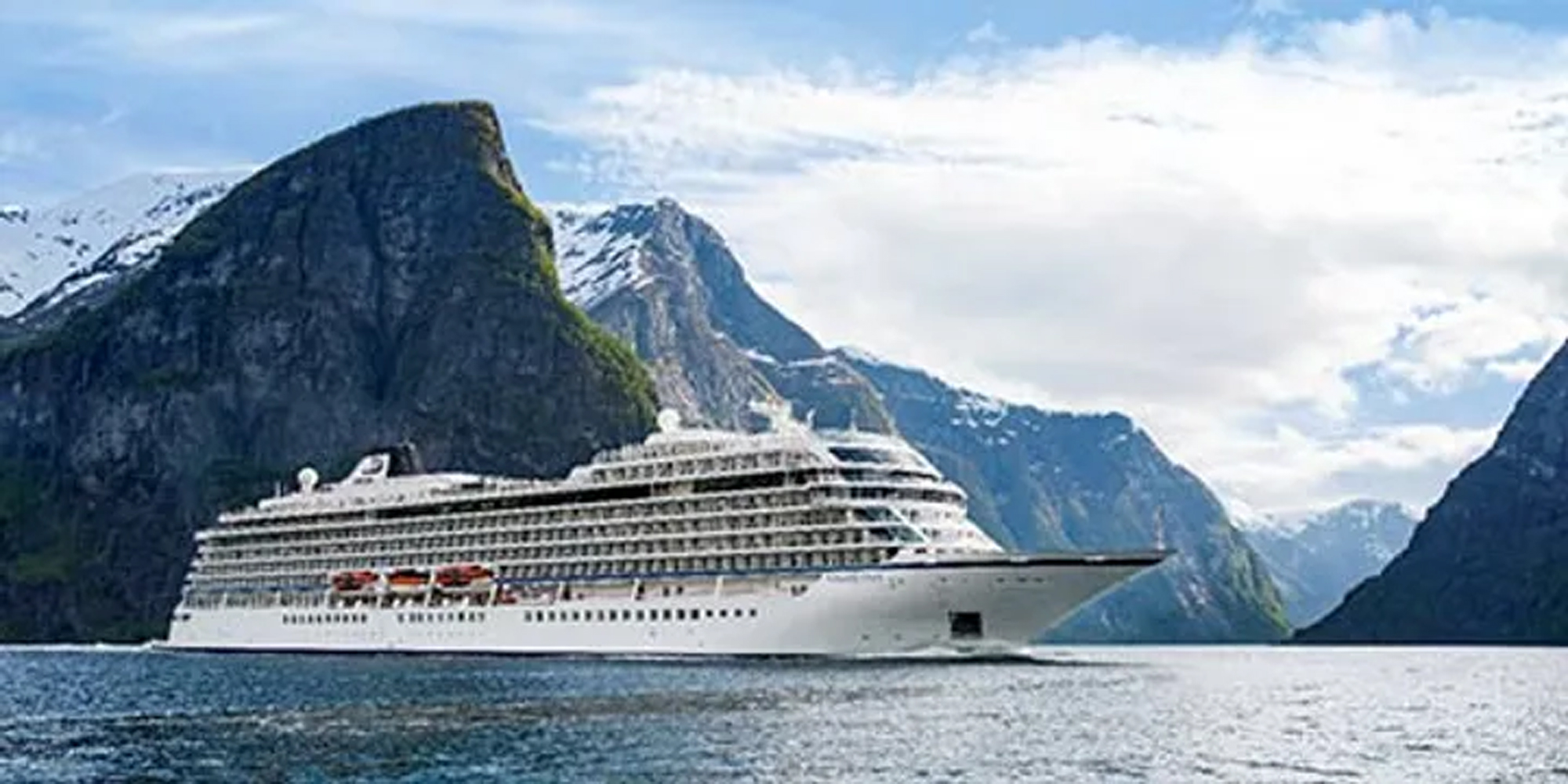 Cruise Ship in Majestic Fjord Landscape A large white cruise ship sailing through a stunning fjord with steep, snow-capped mountains