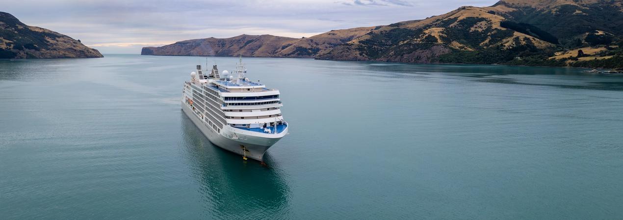 Cruise Ship in New Zealand Fjord Landscape Silversea cruise ship sailing through a scenic fjord with dramatic terrain