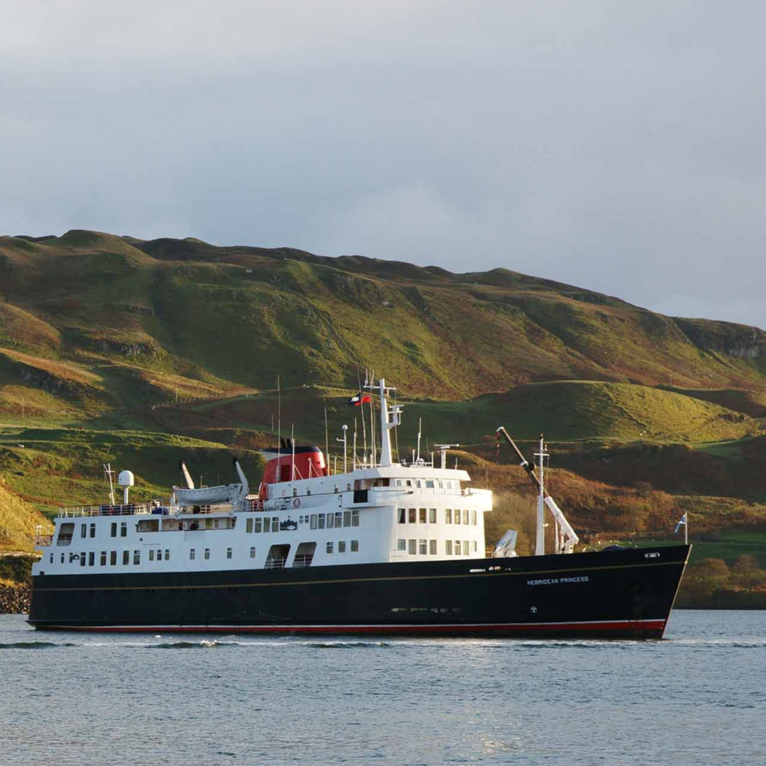 Hebridean Princess in Scottish Waters The Hebridean Princess, a small luxury expedition cruise ship, anchors in calm waters with dramatic