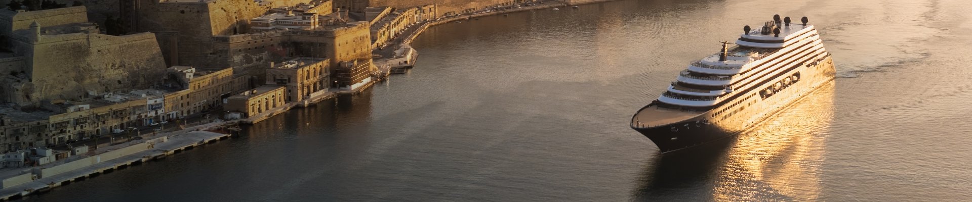 IL_OnboardAmenities_LandingHero_1920x400 Luxury Ritz-Carlton yacht docked in a Mediterranean harbor at golden hour