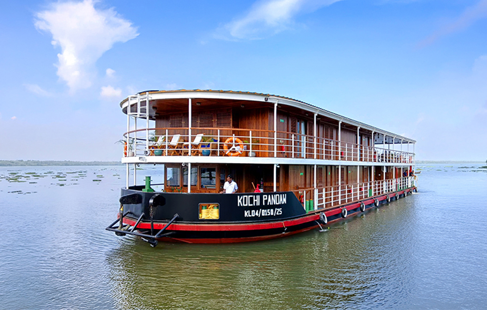 Pandaw riverboat in Kerala backwaters surrounded by tropical scenery