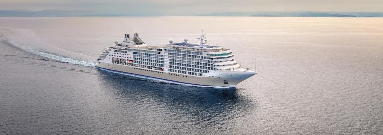 Luxury Cruise Ship at Sea Silversea luxury cruise ship at sea with misty horizon