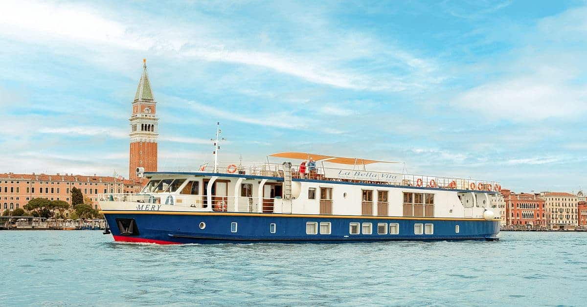 Luxury River Cruise Boat in Venice A modern luxury river cruise vessel named 'Mery' navigates the turquoise waters of the Grand Canal