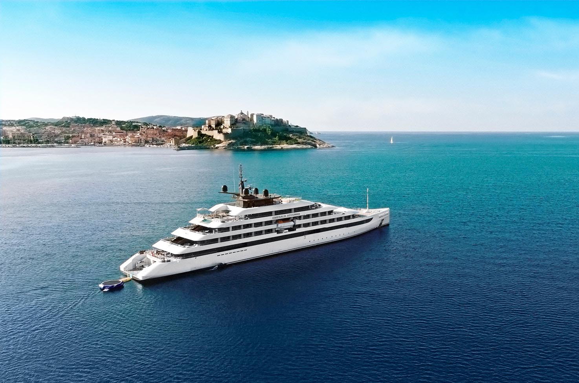 Luxury Yacht near Coastal Mediterranean Town Emerald Azzurra luxury yacht anchored near a historic coastal Mediterranean town