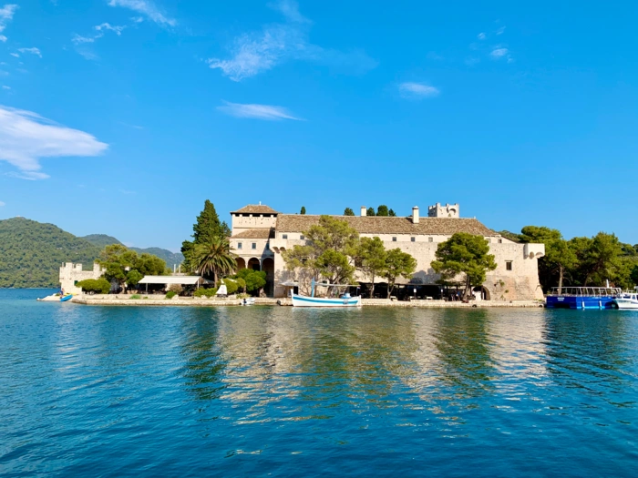 Medieval fortress on a narrow peninsula in crystal-clear turquoise Adriatic waters