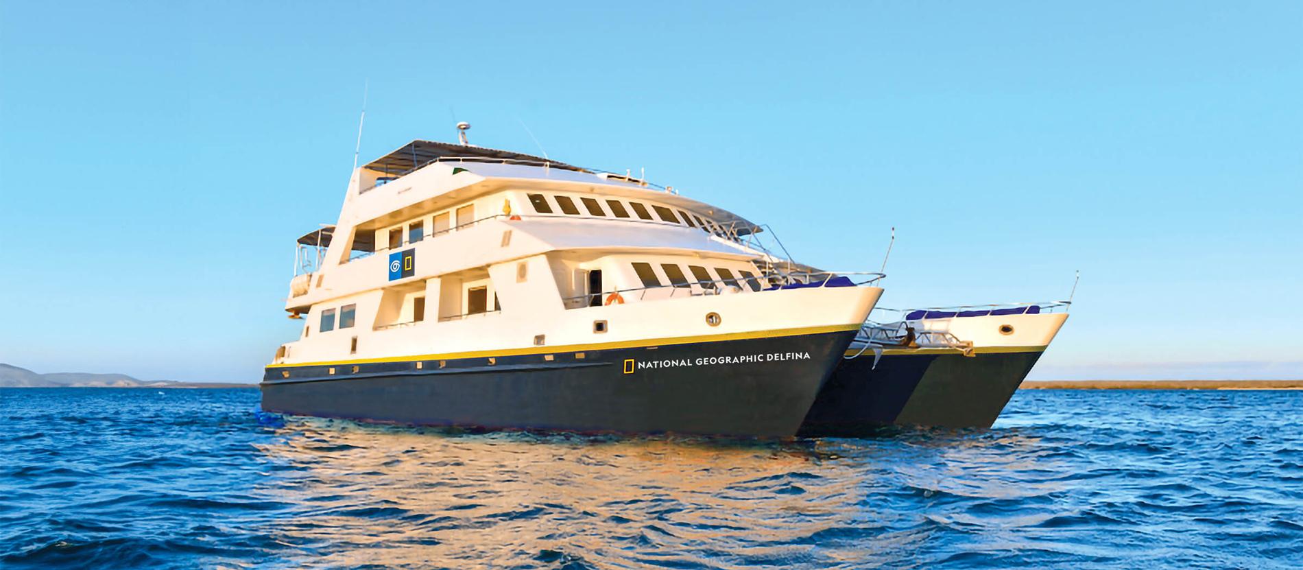 National Geographic Delfina Cruise Ship at Sea The National Geographic Delfina, a sophisticated expedition cruise vessel, anchors in crystalline
