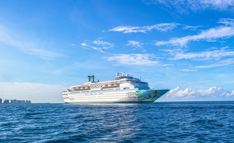 Norwegian Cruise Sailing Blue Waters Norwegian Cruise Line ship sailing on bright blue ocean waters