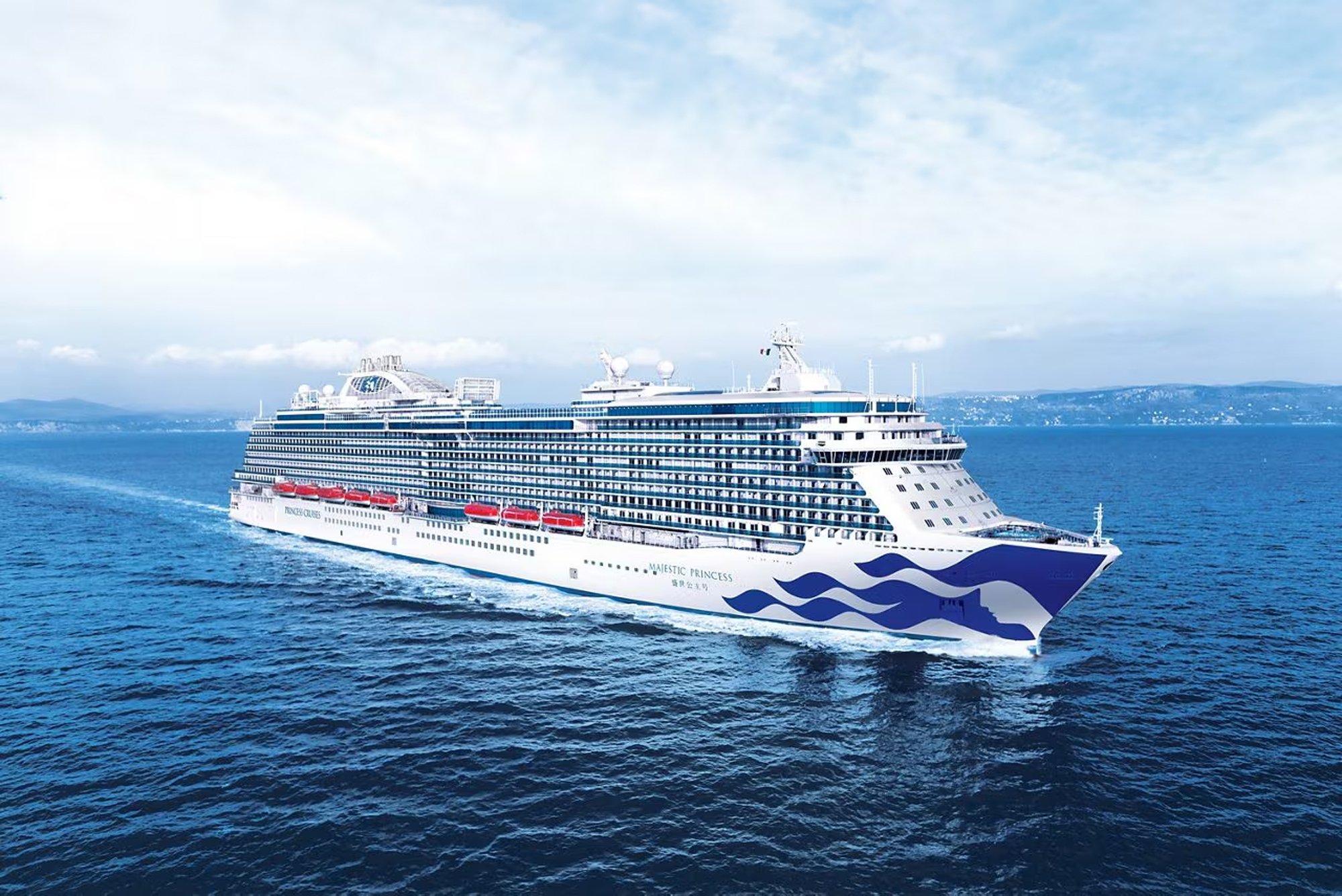 Princess Cruise Ship at Sea A large white and blue Princess cruise ship sailing on open blue waters with a misty coastline