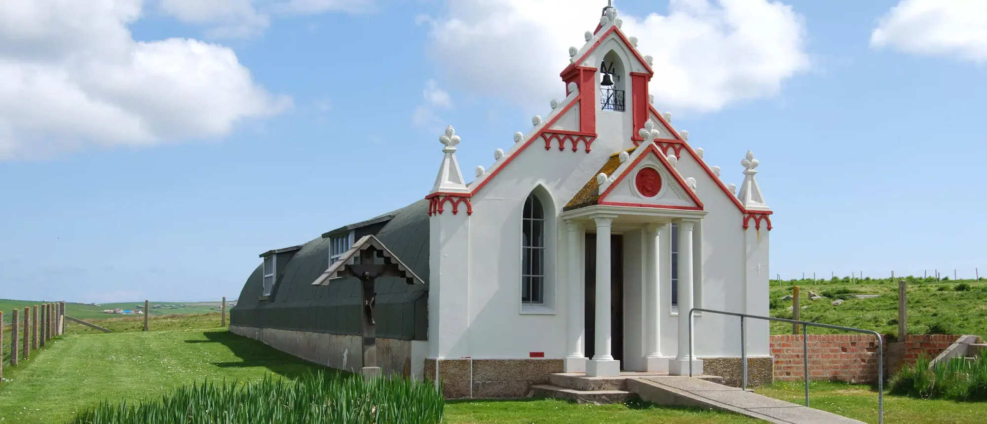 Red and White Chapel on Scottish Highland A charming small chapel featuring distinctive red and white Victorian architecture sits isolated