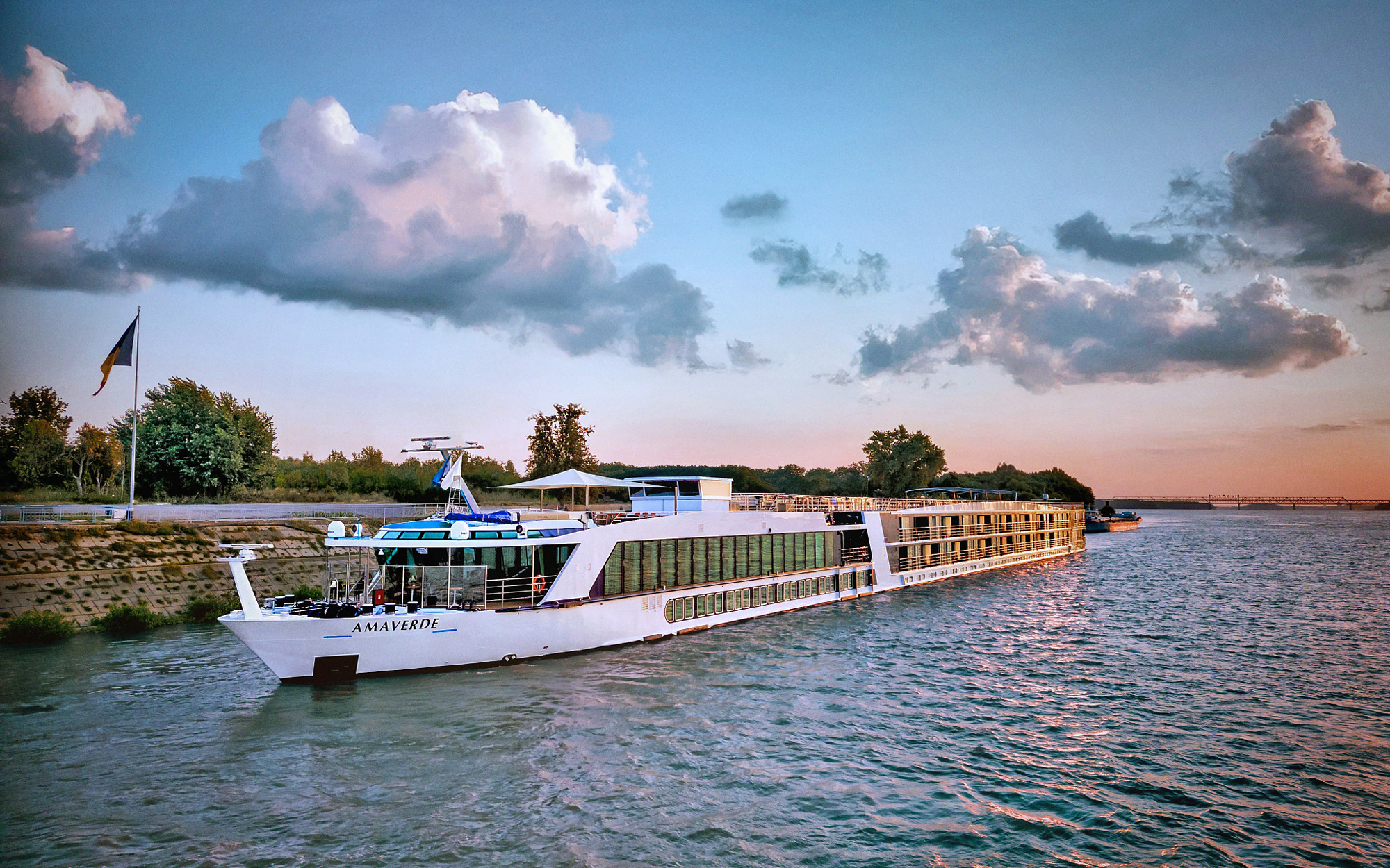 River Cruise Ship Amaverde at Sunset AmaVerde river cruise ship docked along a river at sunset