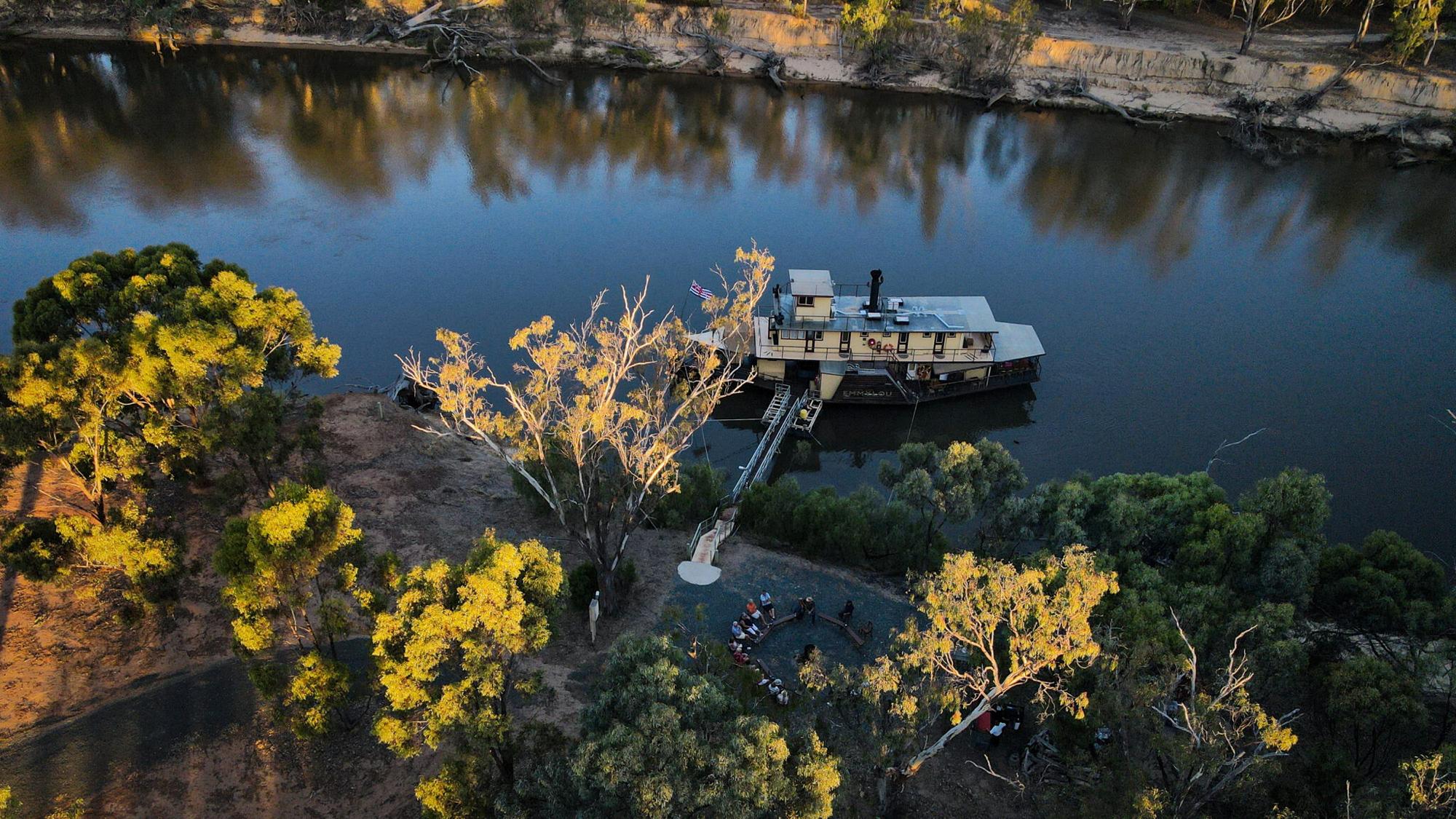 River Cruise on Murray River, Australia An aerial view of a paddlewheel riverboat moored along the Murray River in Australia