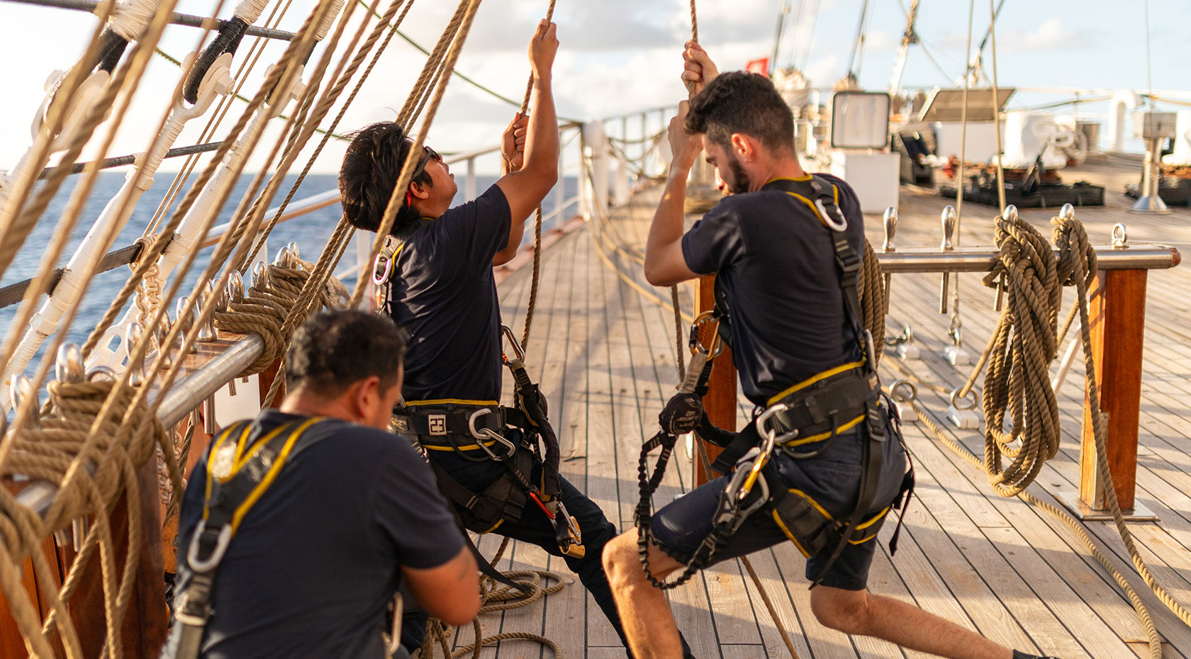 Sea Cloud crew setting sails by hand on deck