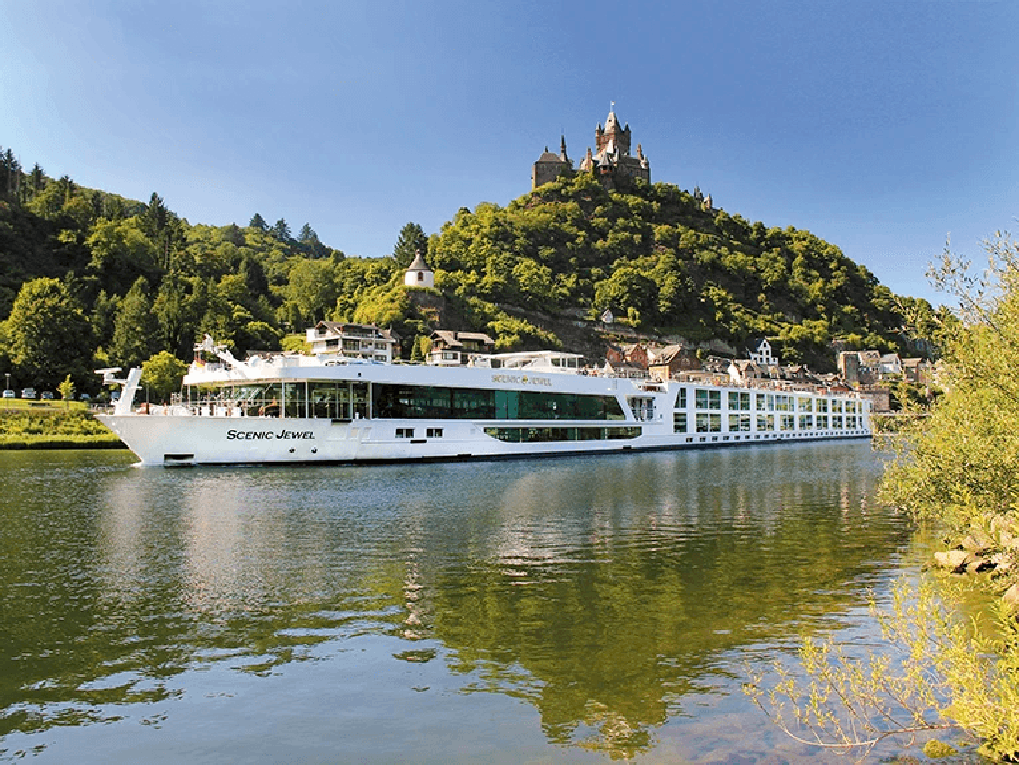 Scenic Jewel River Cruise Past Hilltop Castle Scenic Jewel river cruise ship sailing past a hilltop castle on the Danube