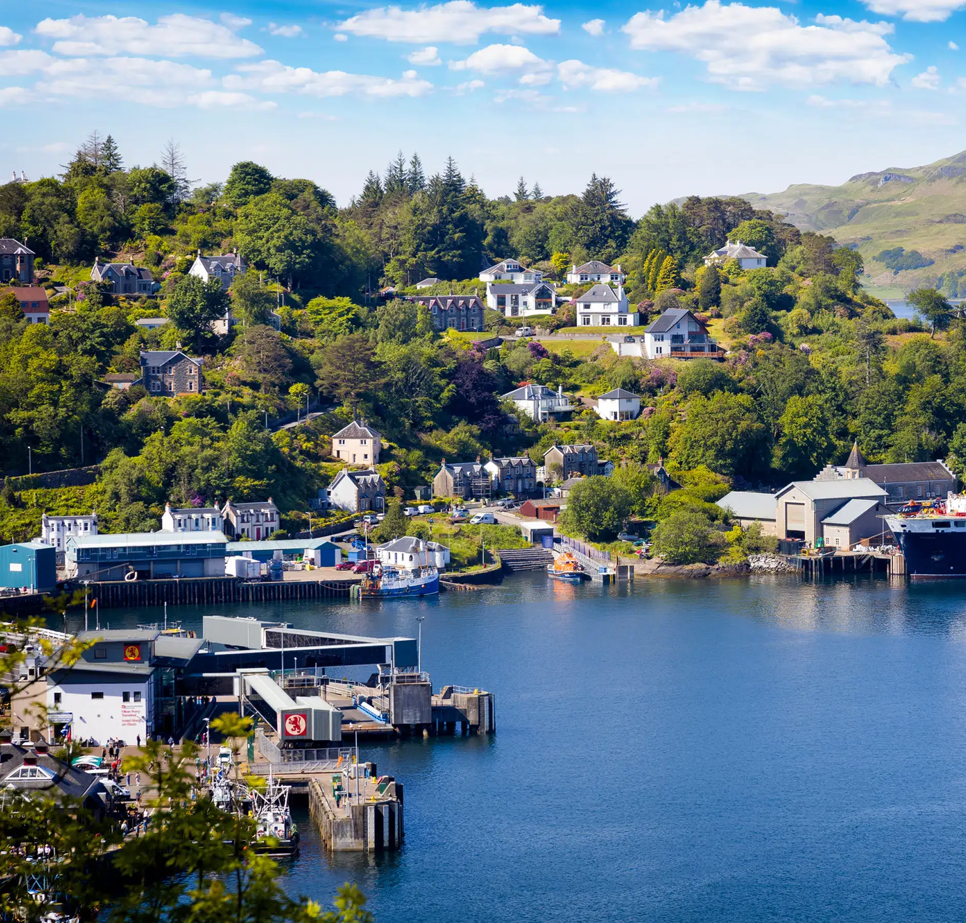 Scottish Highland Village Harbor View A picturesque Scottish waterfront village nestled in a lush valley with traditional stone