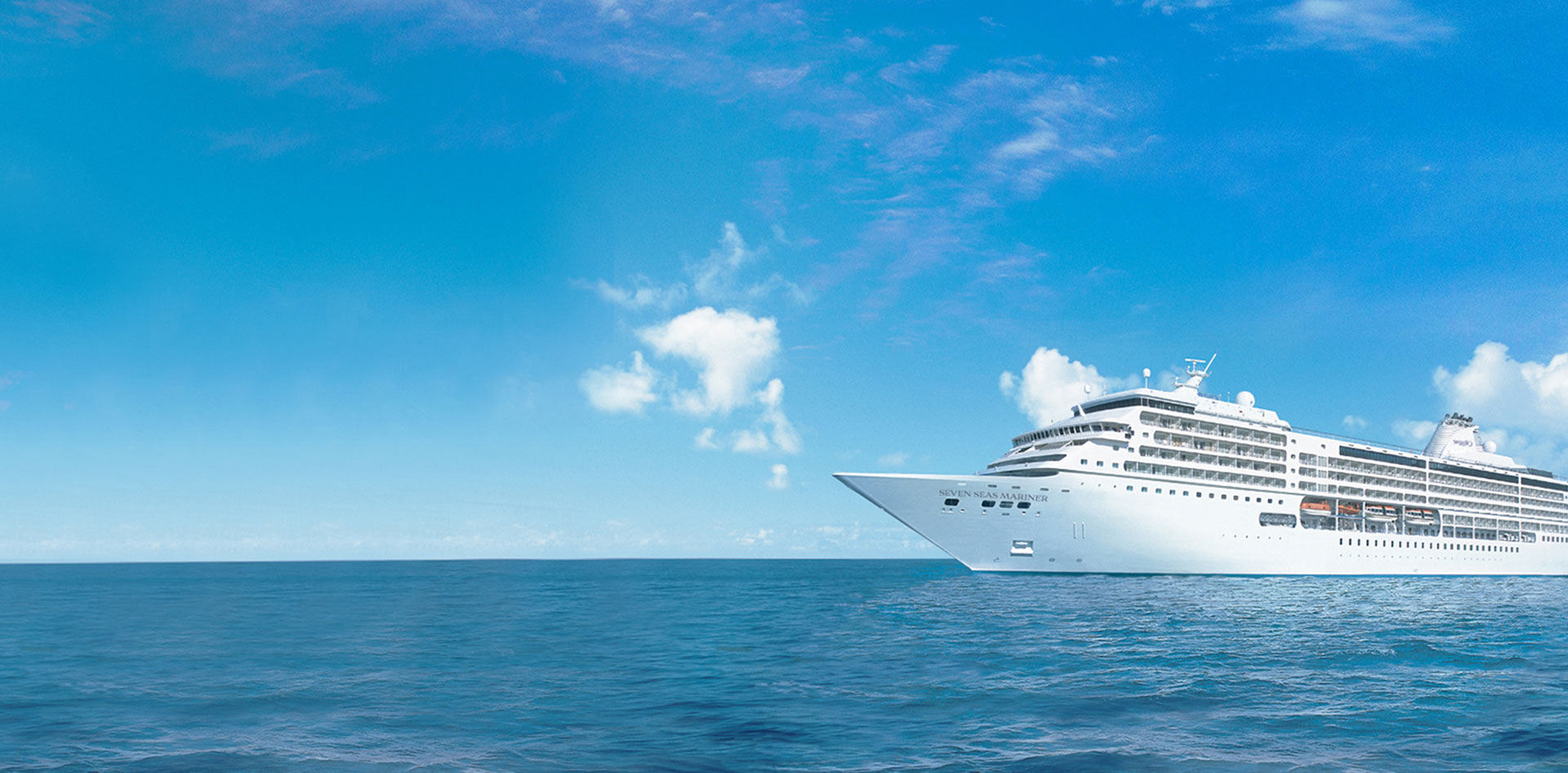 White Cruise Ship on Blue Ocean Regent Seven Seas luxury cruise ship sailing on calm blue ocean
