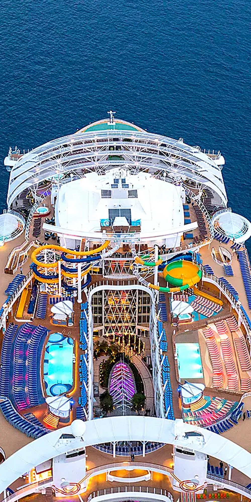 Aerial View of Cruise Ship Pool Deck An overhead aerial view of a modern cruise ship's pool deck and upper areas, featuring colorful