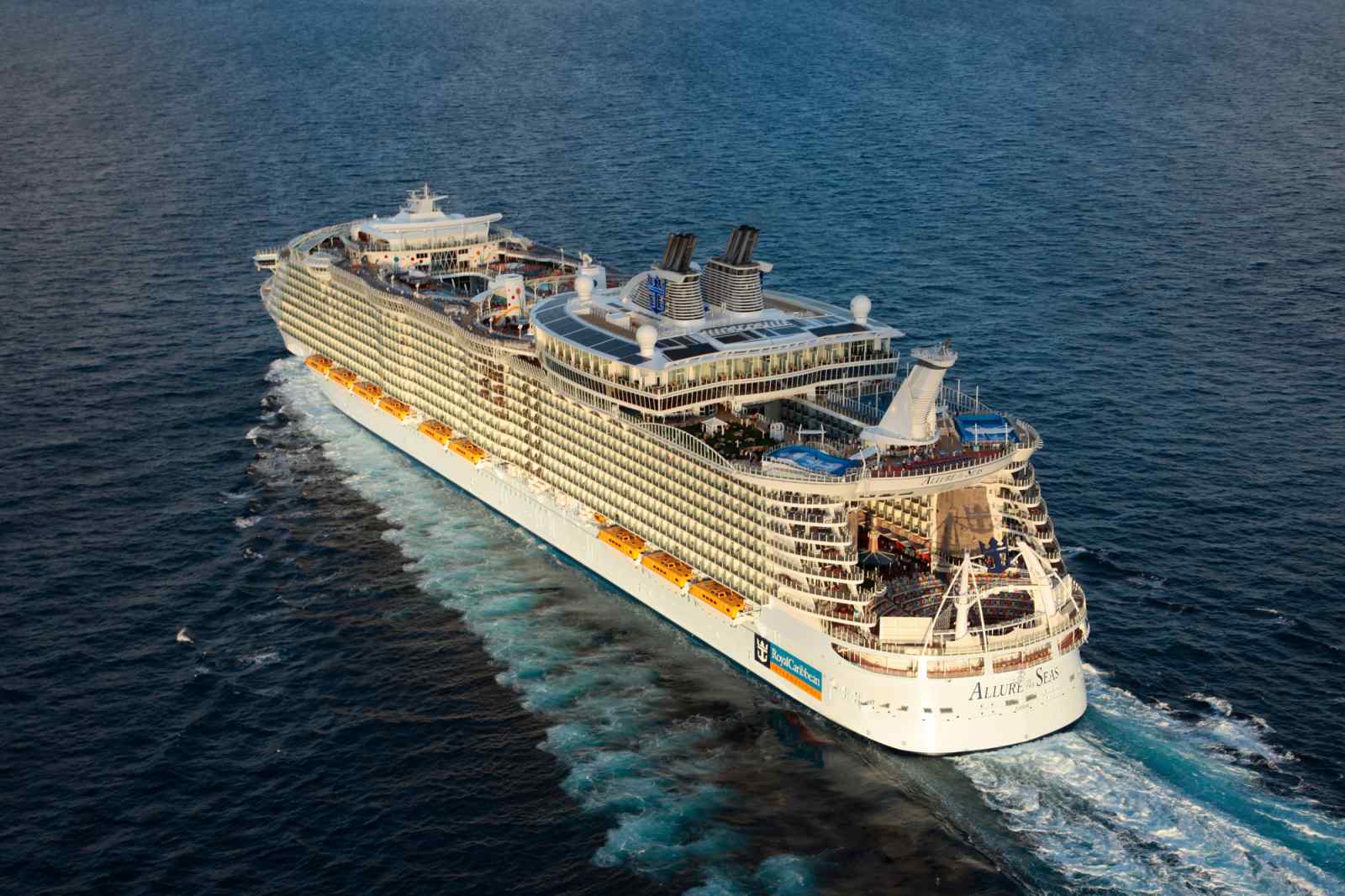 Allure of the Seas Aerial Ocean View An aerial view of the Allure of the Seas, a massive modern cruise ship, positioned in shallow