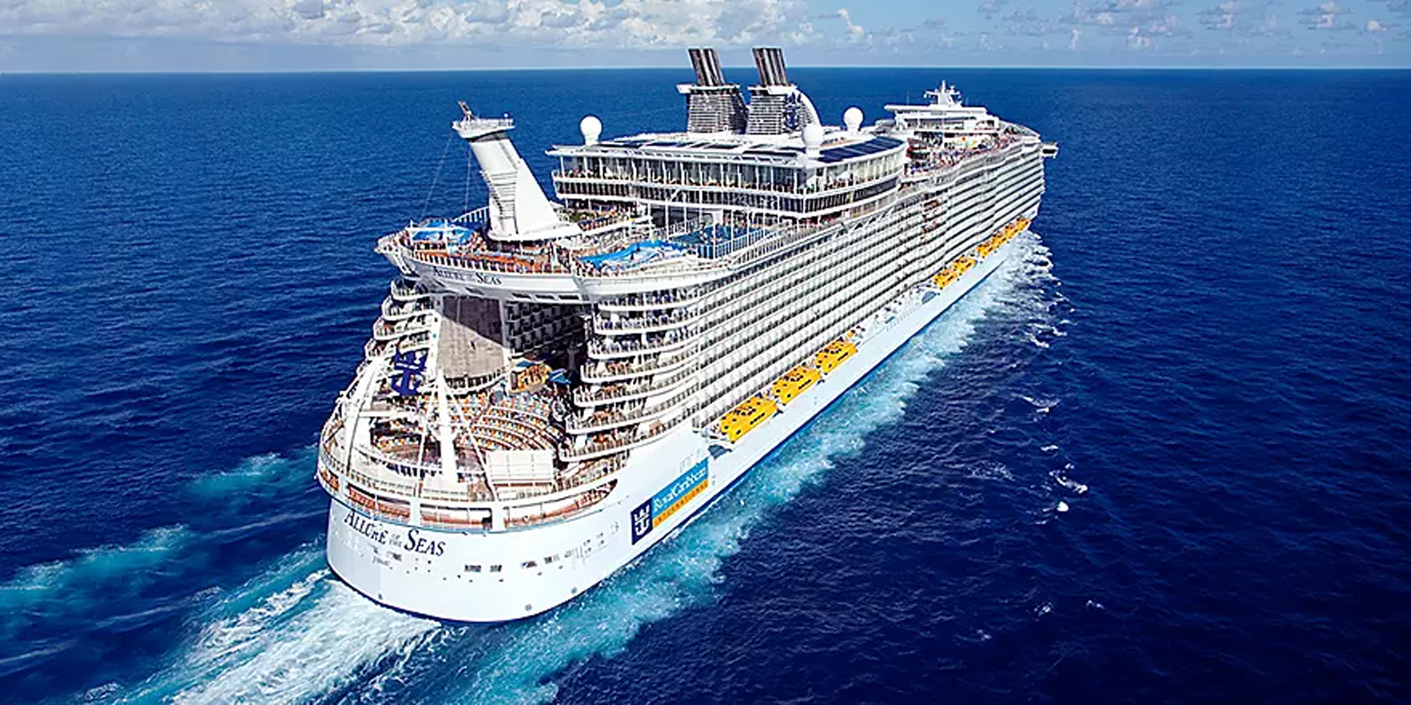 Allure of the Seas Aerial View at Sea An aerial photograph of the Allure of the Seas, a massive modern cruise ship, sailing through clear