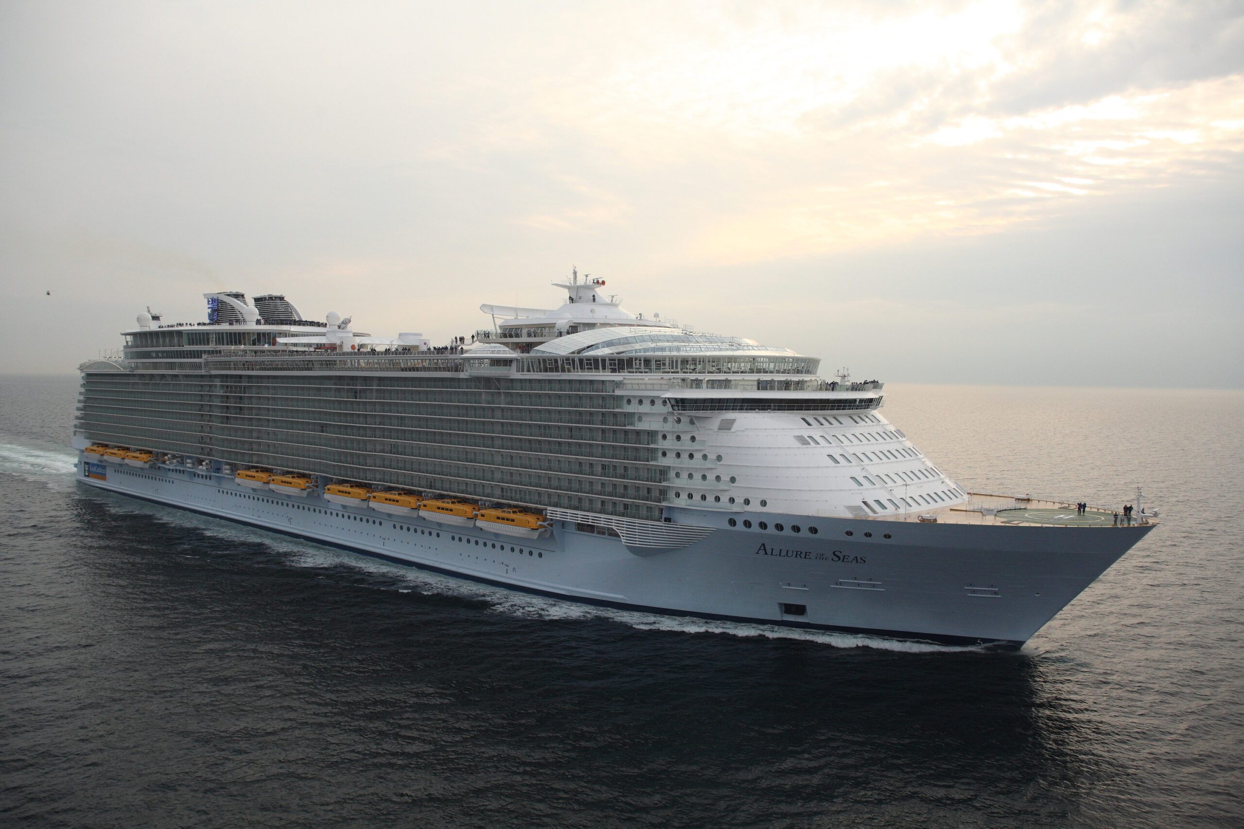 Allure of the Seas Cruise Ship at Sea A massive Royal Caribbean cruise ship sailing on open waters during a soft, overcast day