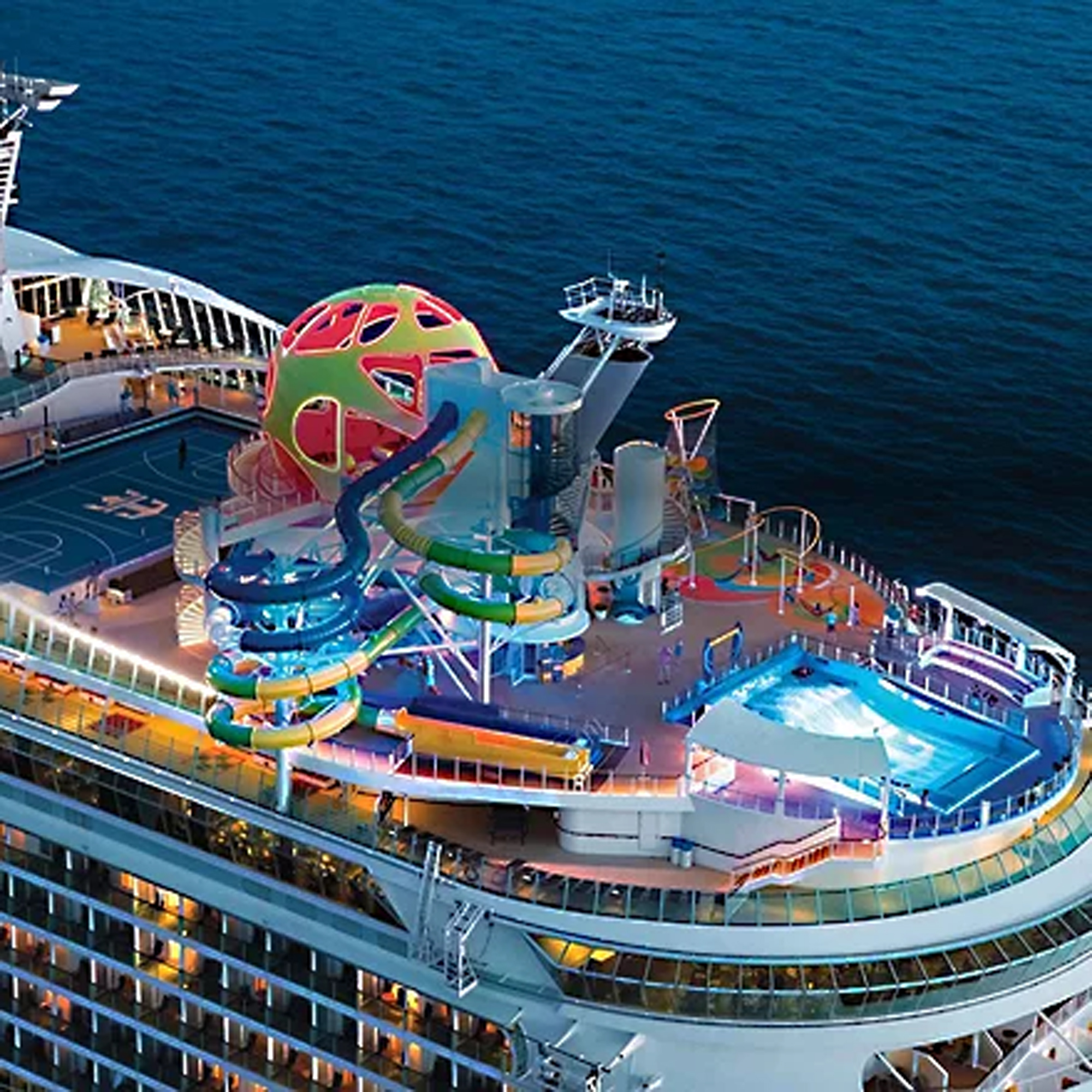 Cruise Ship Waterslide and Pool Deck An aerial view of a modern cruise ship's lido deck featuring a vibrant, multi-colored waterslide