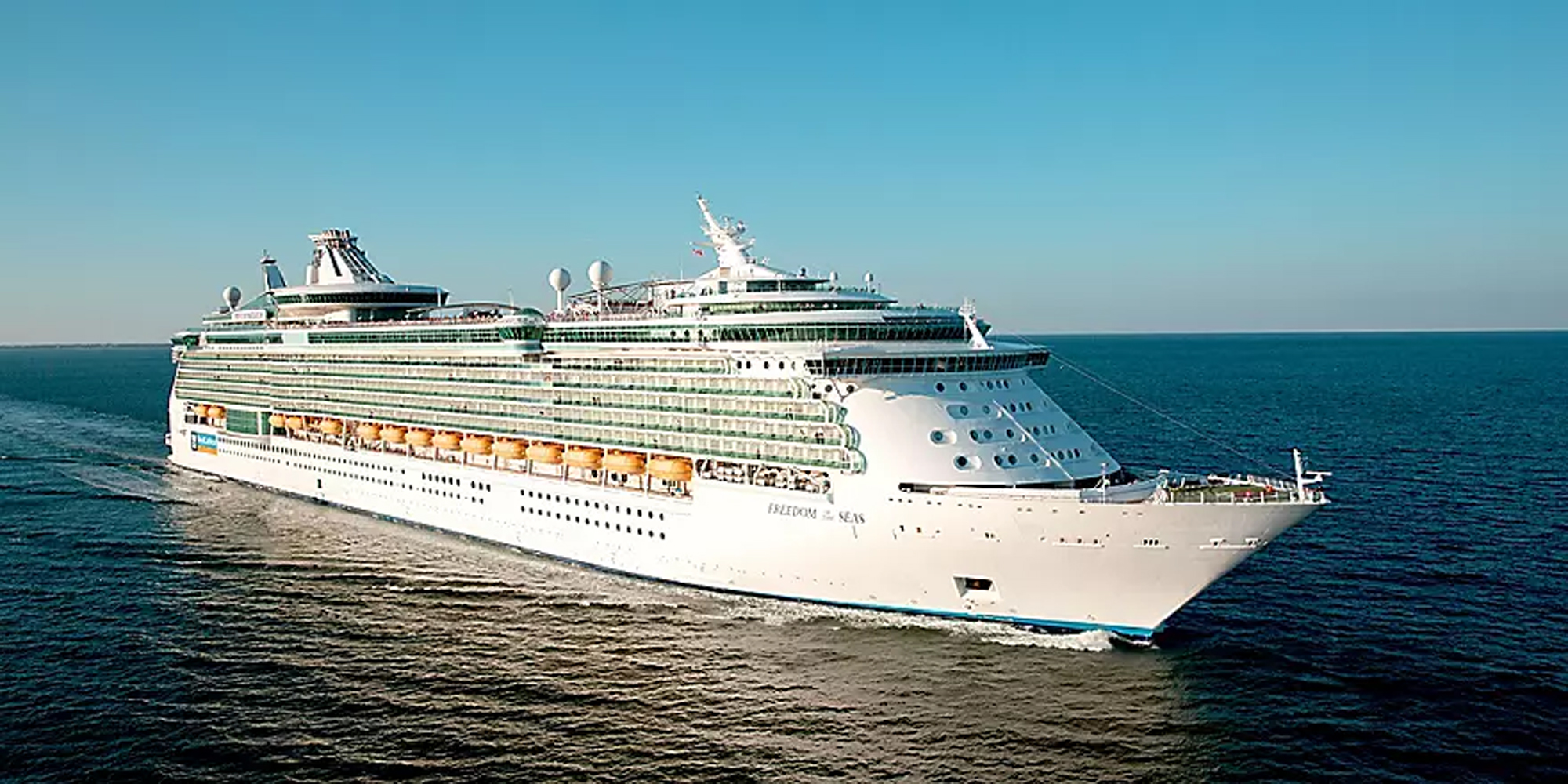 Freedom of the Seas Cruise Ship at Sea A large modern cruise ship photographed from an aerial perspective sailing on turquoise blue waters