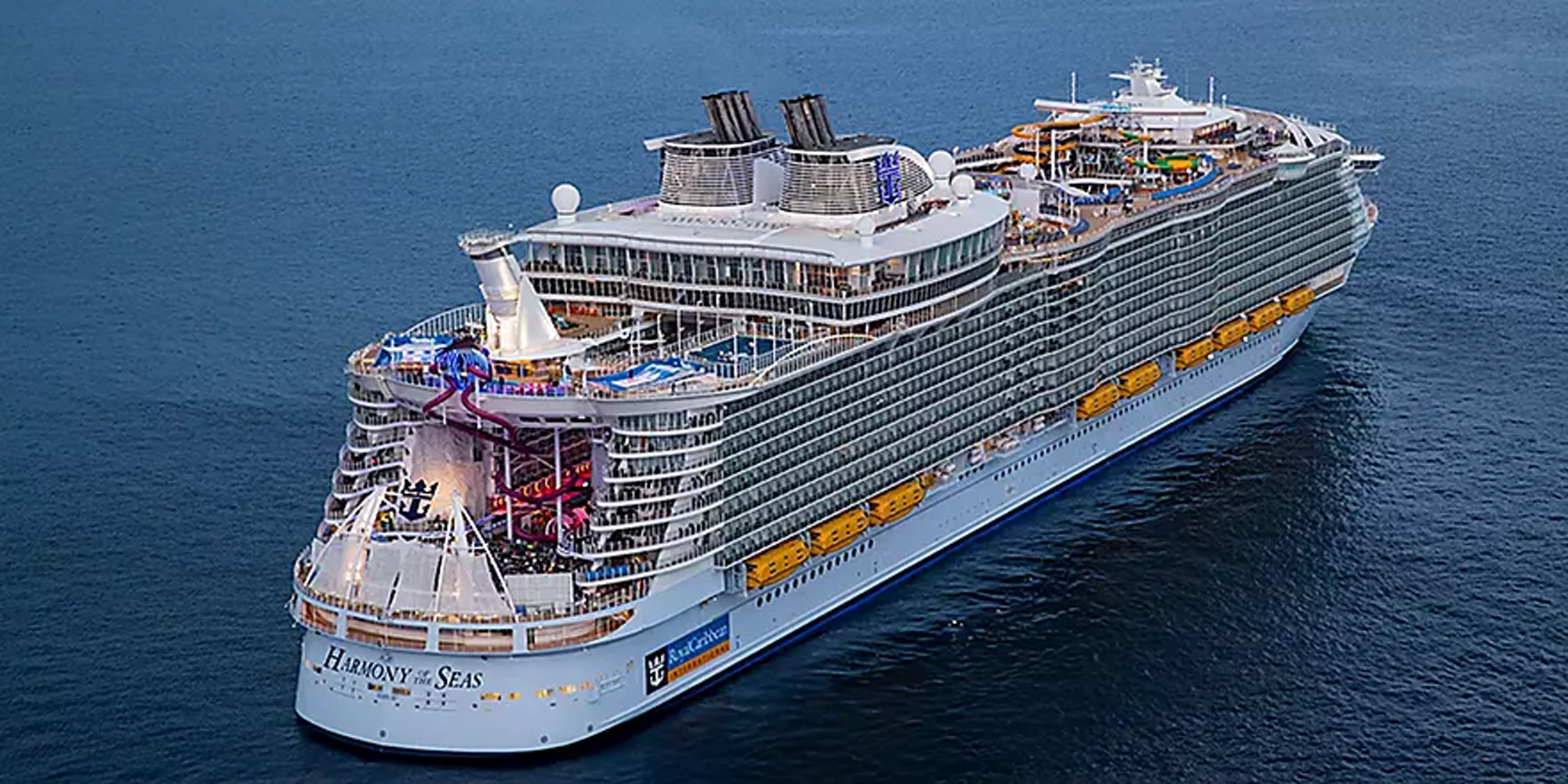 Harmony of the Seas Aerial View An aerial photograph of a massive modern cruise ship at sea, showcasing its distinctive white hull