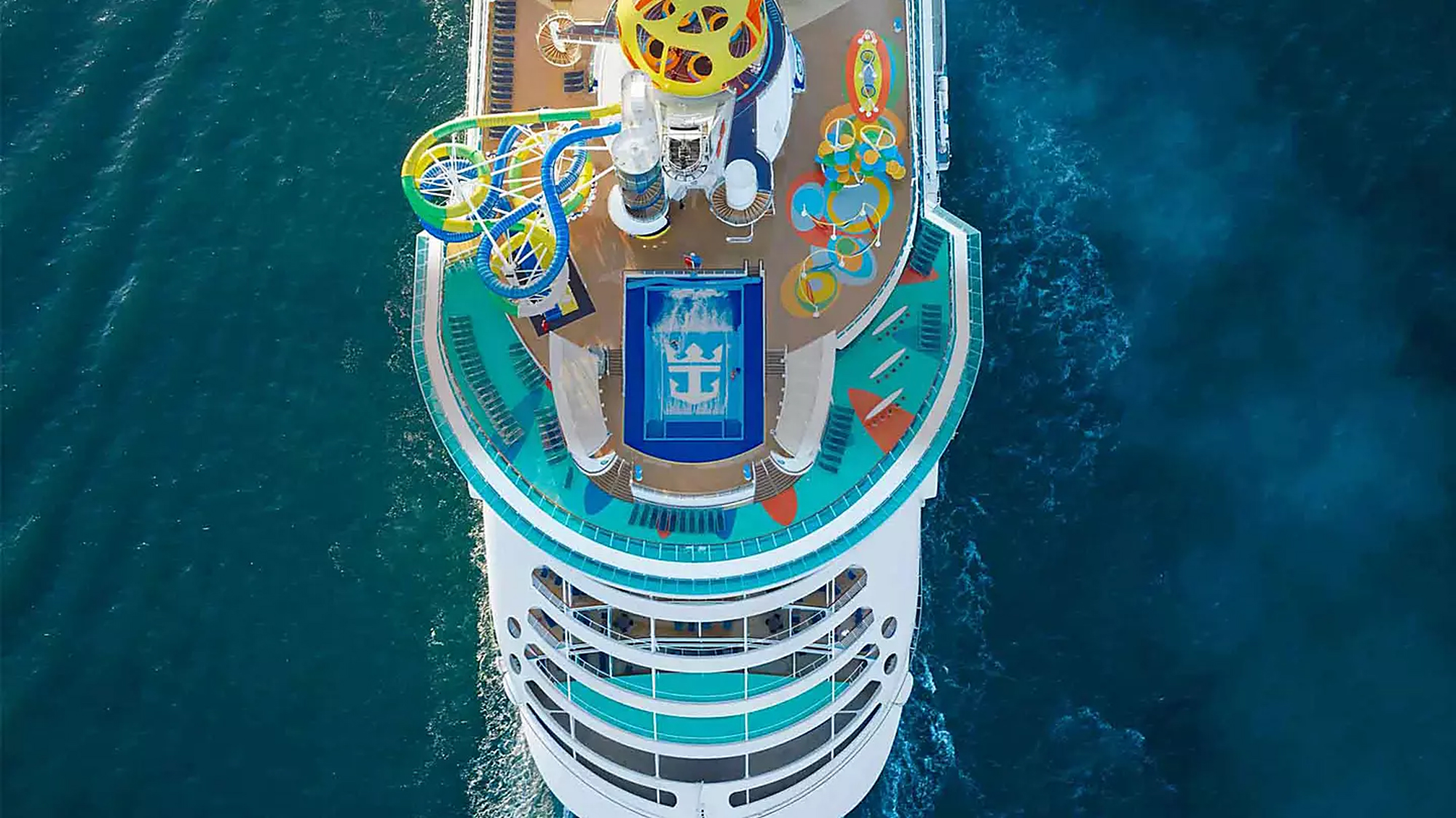 Independence of the Seas Aerial Deck View An overhead aerial view of a large cruise ship's upper deck featuring vibrant water slides