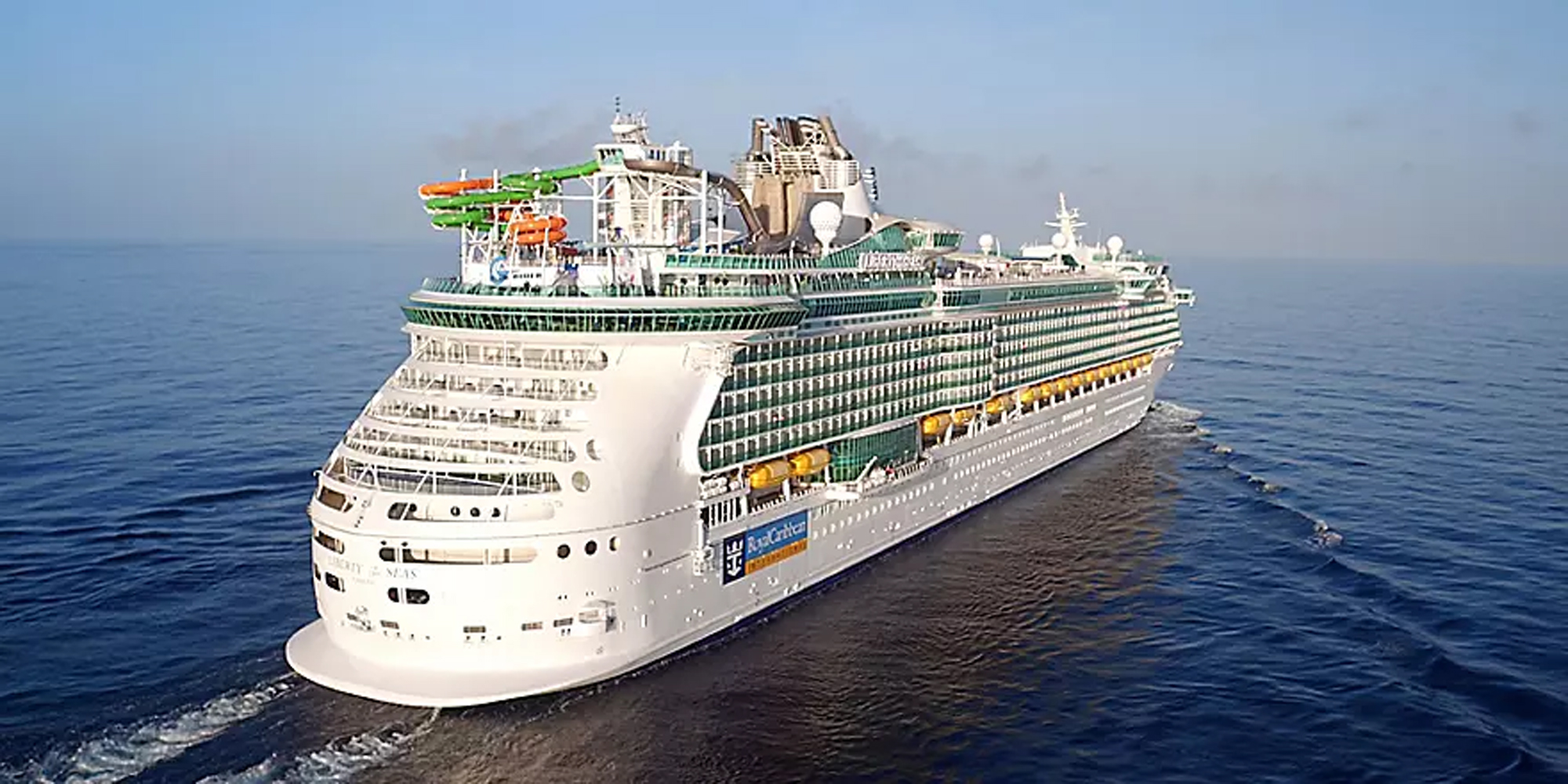 Large Cruise Ship Aerial Exterior View A large modern cruise ship photographed from an aerial perspective sailing on calm blue ocean