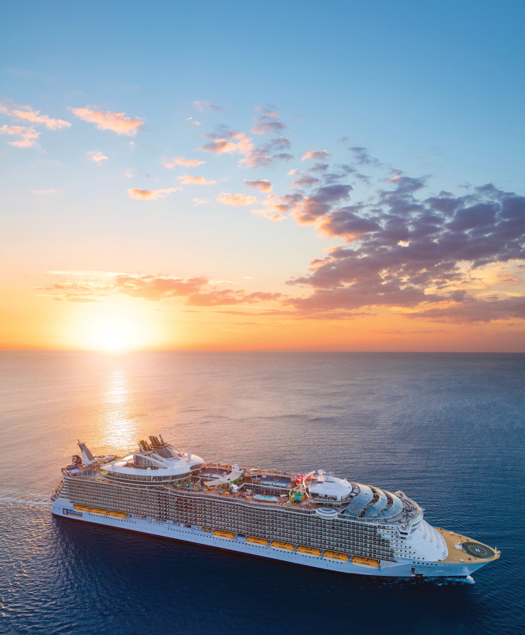 Luxury Cruise Ship at Golden Hour Sunset A magnificent large cruise ship sails through calm blue waters during a stunning golden hour
