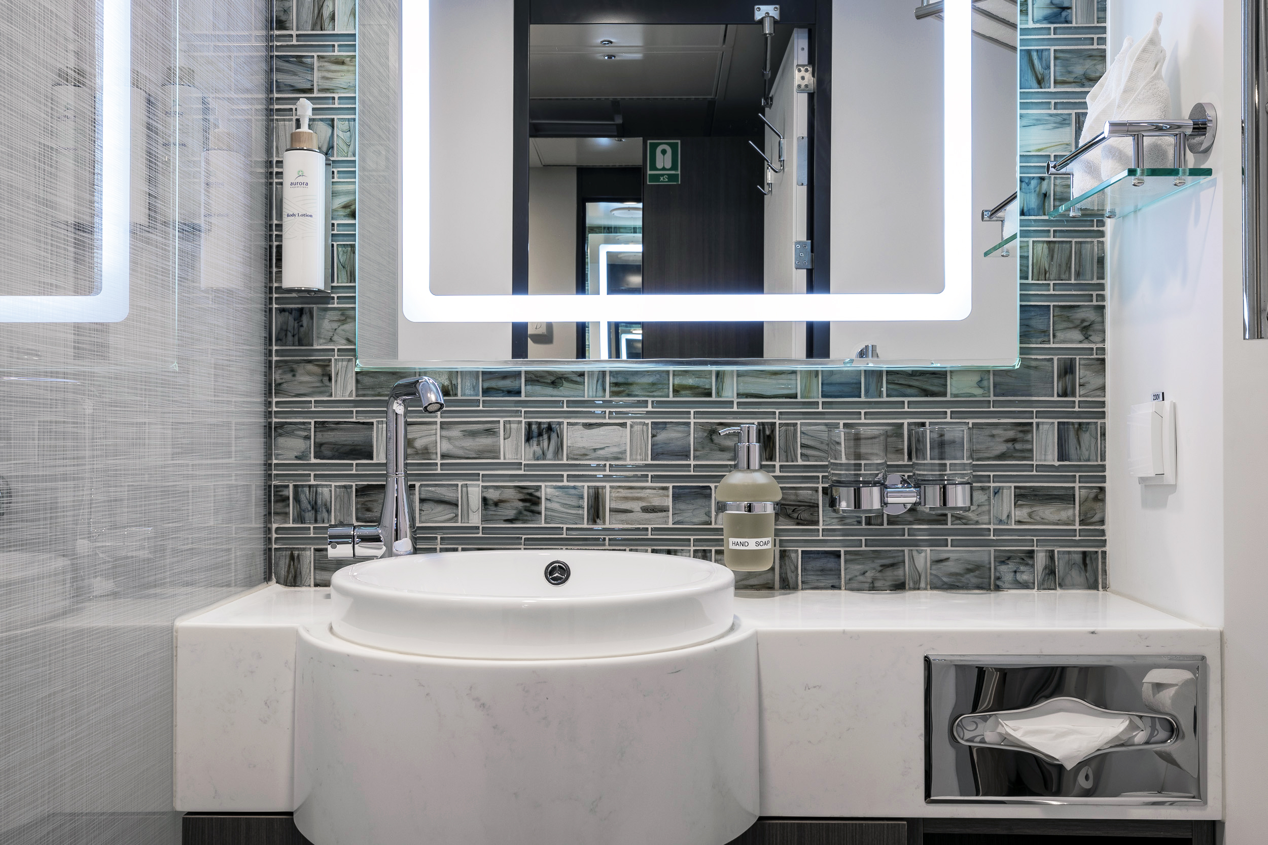 Modern Cruise Ship Bathroom with Marble Vanity A contemporary bathroom aboard a cruise ship featuring a sleek white marble vanity with
