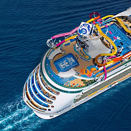 Navigator of the Seas Aerial Deck View An aerial view of a large cruise ship featuring colorful waterslides, multiple deck levels