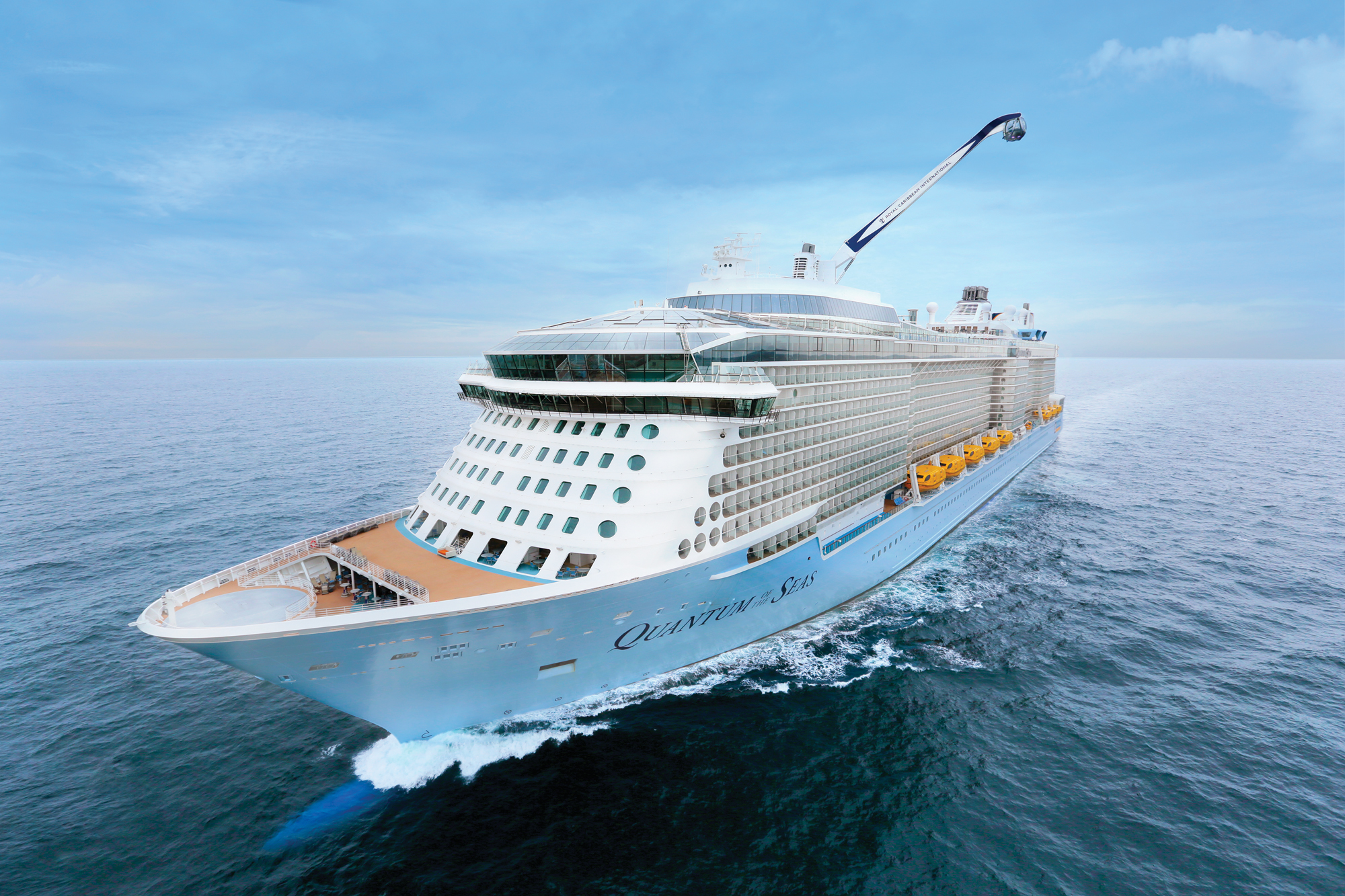 Quantum of the Seas Aerial Ocean View A large modern cruise ship photographed from above, sailing through calm blue ocean waters under