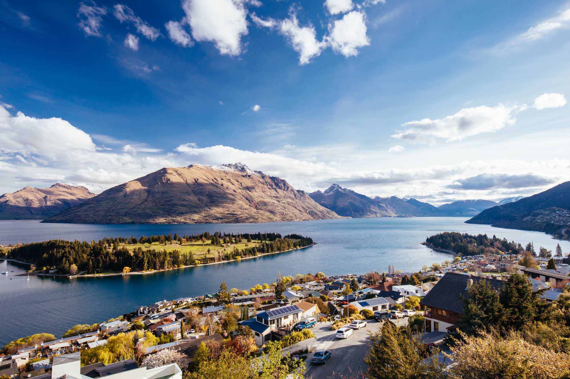 Queenstown Lakeside Town with Mountain Views An aerial view of Queenstown, New Zealand, nestled on the shores of Lake Wakatipu with snow-capped