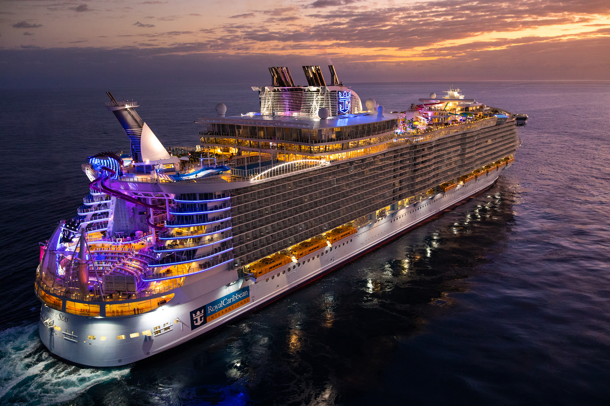 Royal Caribbean Cruise Ship at Dusk A massive modern cruise ship from Royal Caribbean illuminated at twilight, anchored in calm ocean