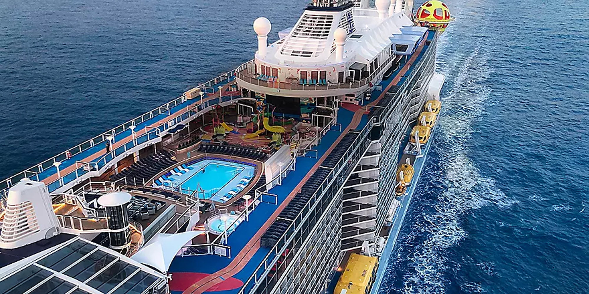 Spectrum of the Seas Aerial Deck View An aerial view of a modern cruise ship showcasing multiple deck levels with a bright blue swimming