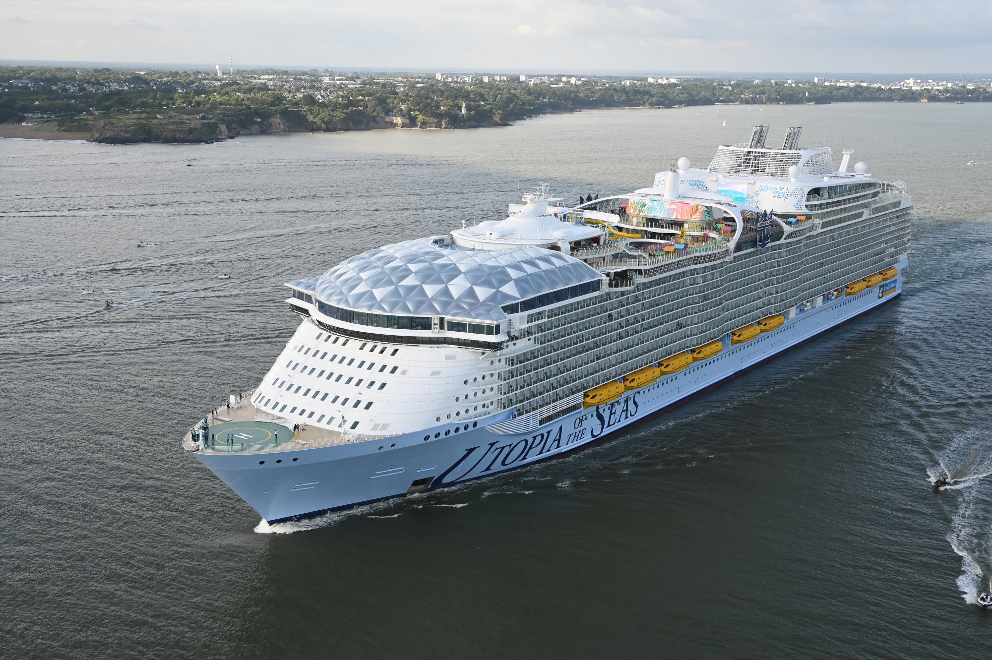Utopia of the Seas Cruise Ship at Port Utopia of the Seas cruise ship with distinctive light blue hull anchored in coastal waters