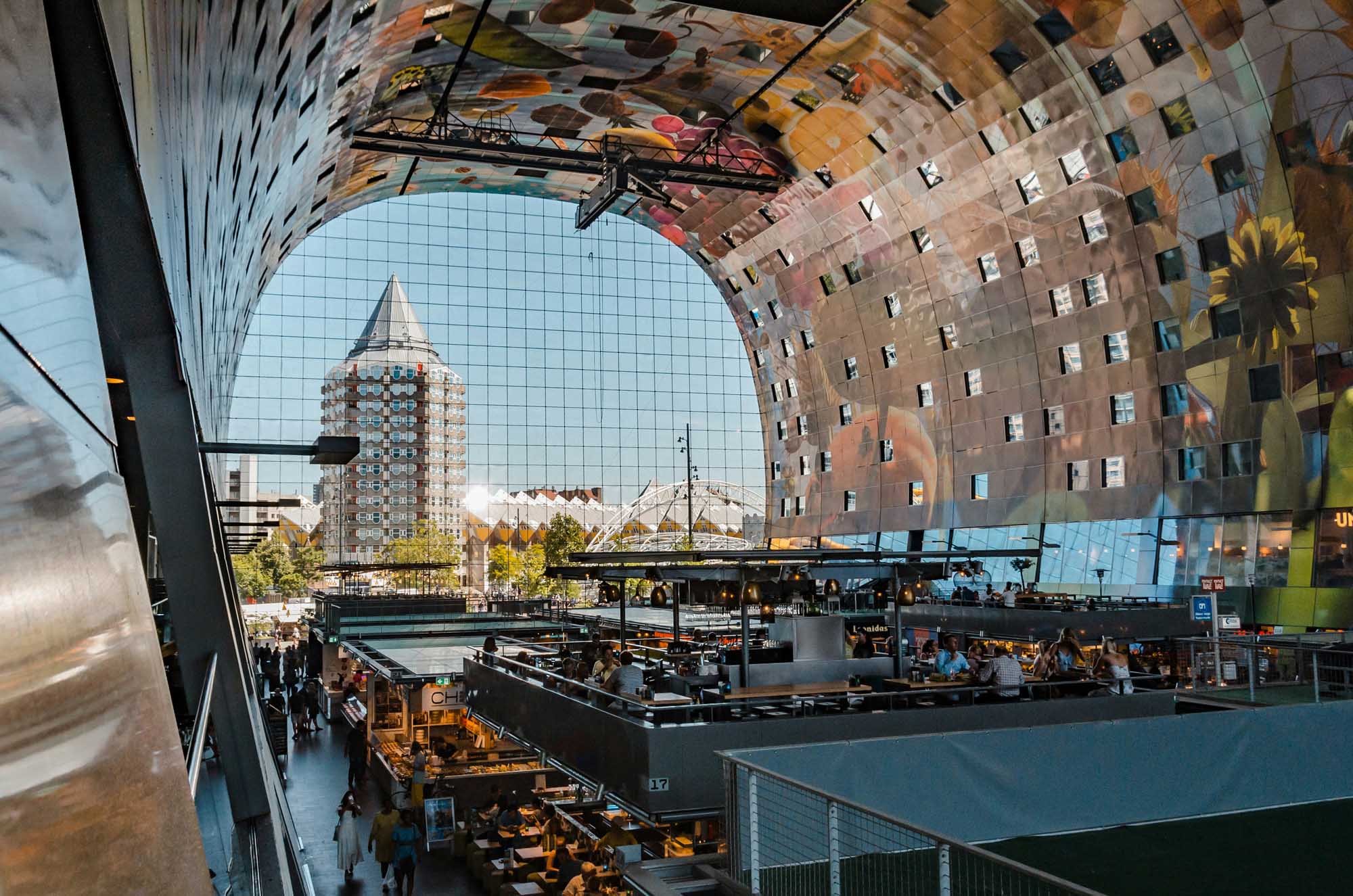 A stunning interior view of Rotterdam's Market Hall (Markthal) featuring its distinctive curved