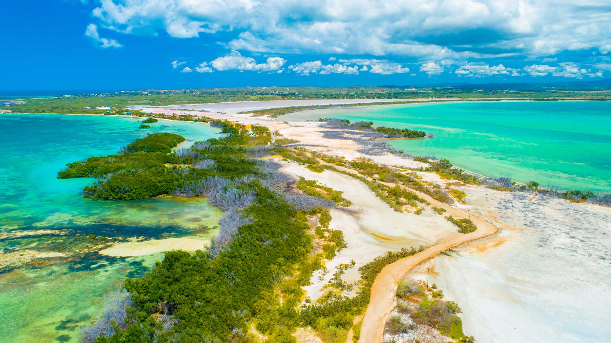 Aerial View of Puerto Rico Coastal Landscape An aerial view of Puerto Rico's stunning coastline featuring Faro Los Morrillos de Cabo Rojo, Playa