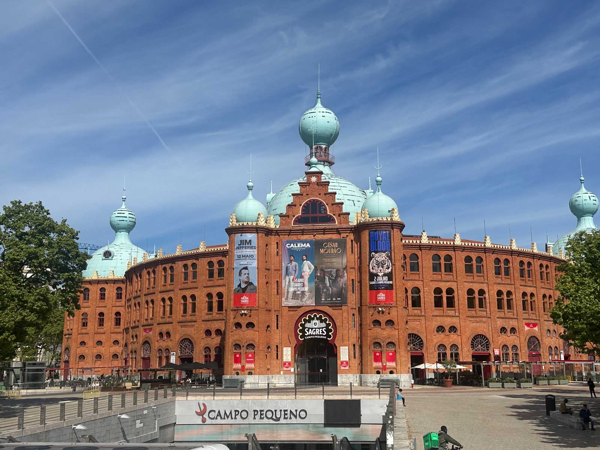 A striking red-brick Neo-Moorish bullring (Campo Pequeno) in Lisbon, Portugal, featuring