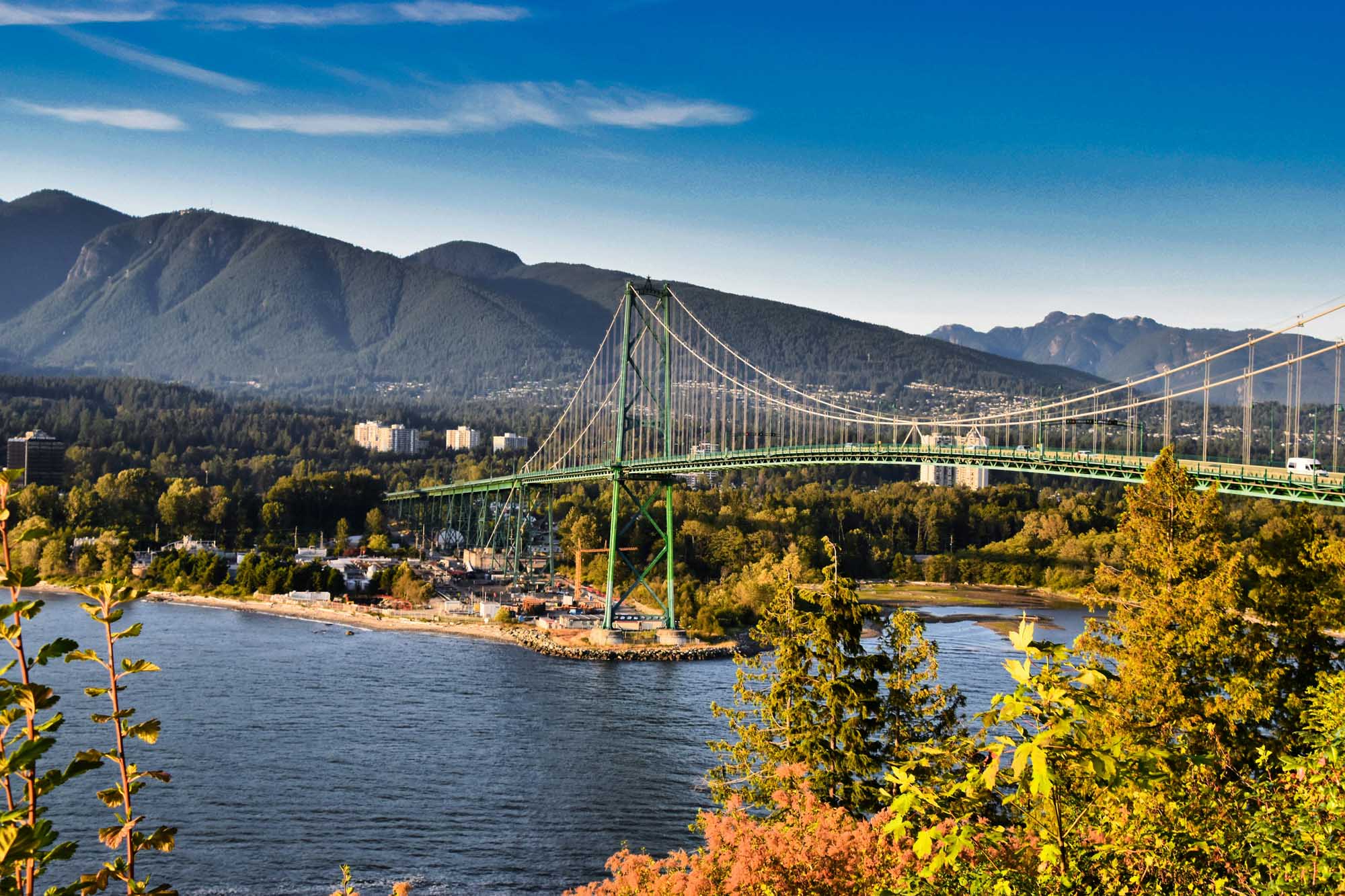 Lions Gate Bridge Spanning Burrard Inlet A stunning view of the iconic Lions Gate Bridge, a green suspension bridge spanning Burrard Inlet