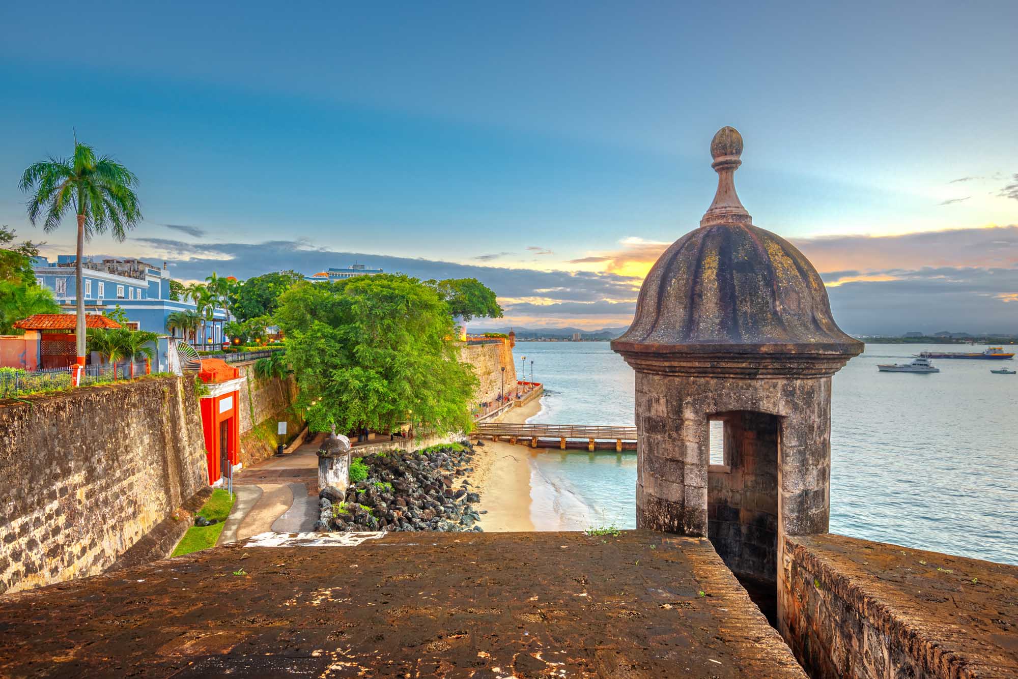 San Juan’s Paseo de la Princesa at Dusk A picturesque waterfront scene at sunset along Puerto Rico's historic Paseo de la Princesa