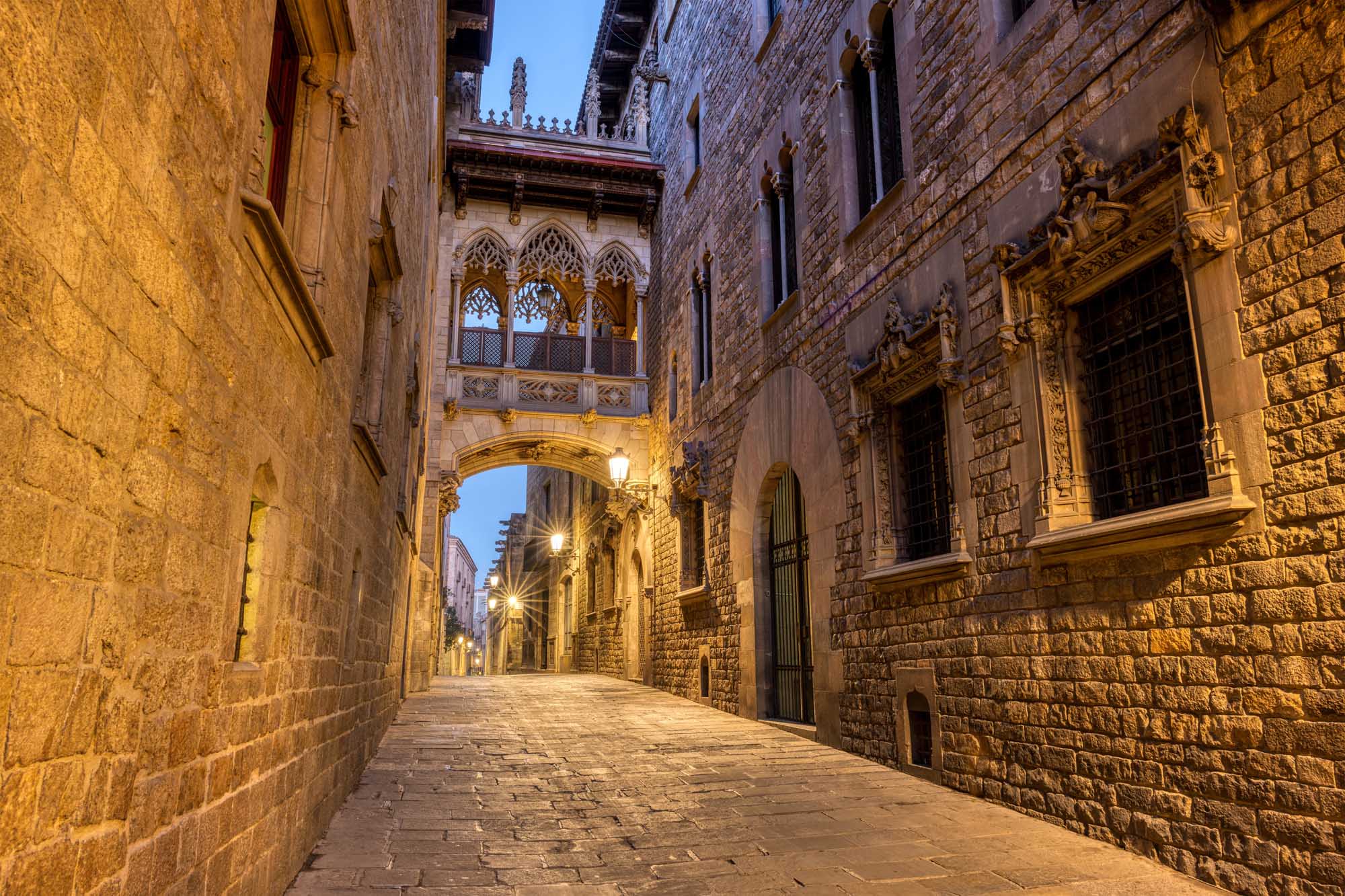 A stunning twilight view of Barcelona's historic Barrio Gótico (Gothic Quarter) featuring